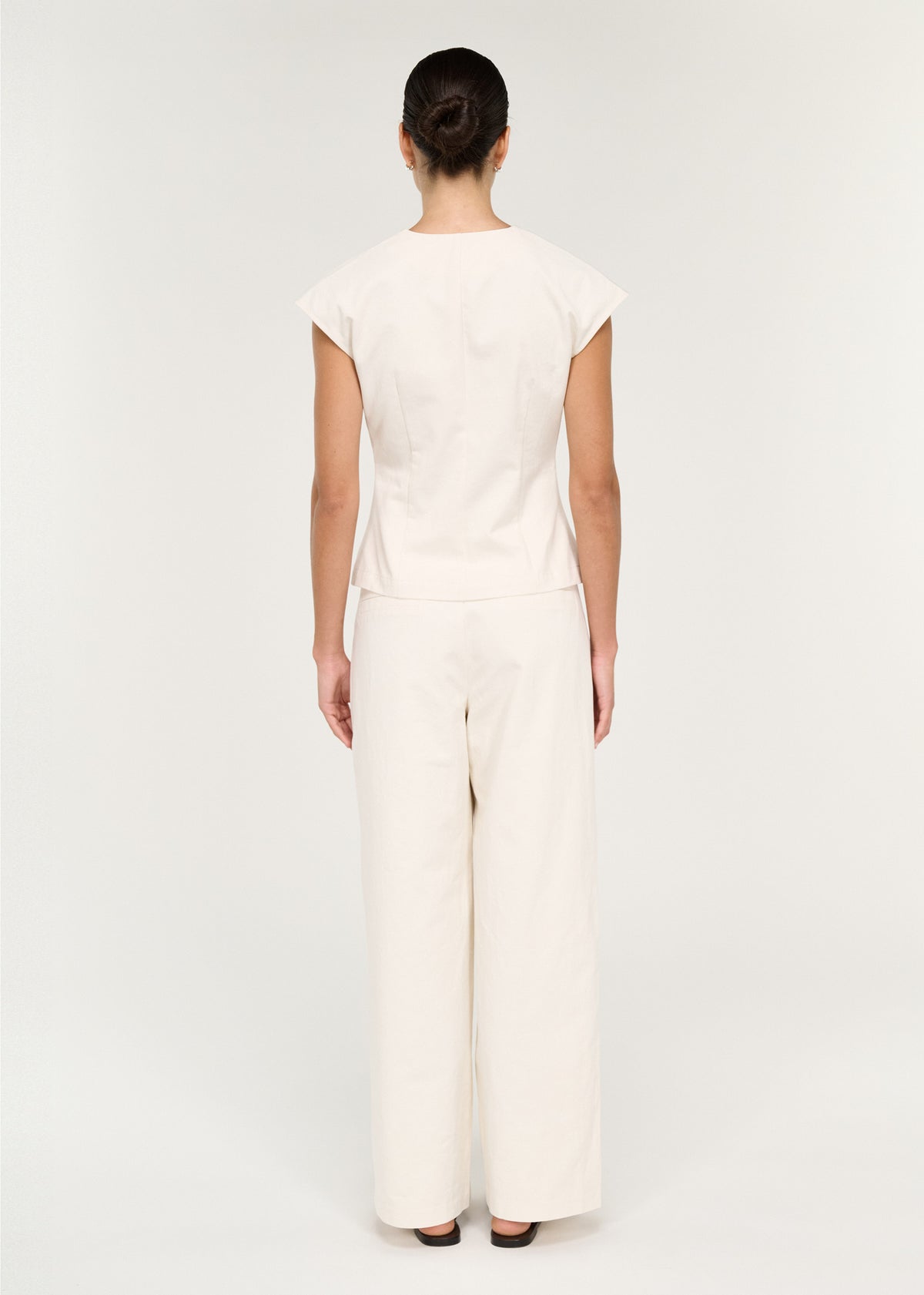 Back view of the Cotton Tie Front Top with Cap Sleeve with a self-fabric tie front detail and metal-tipped ties.