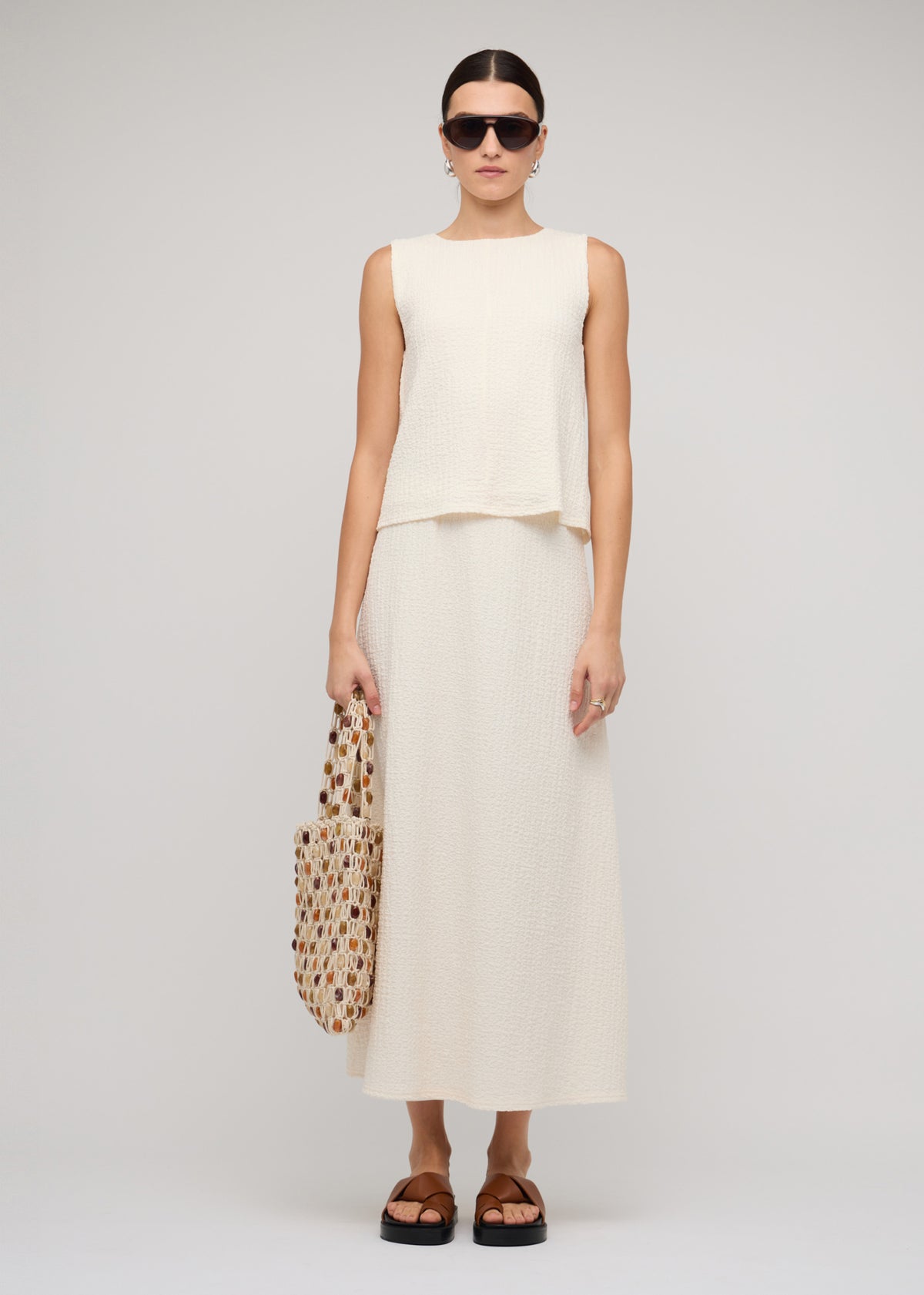 Model wearing Cream A-Line Midi Skirt with a midi length.