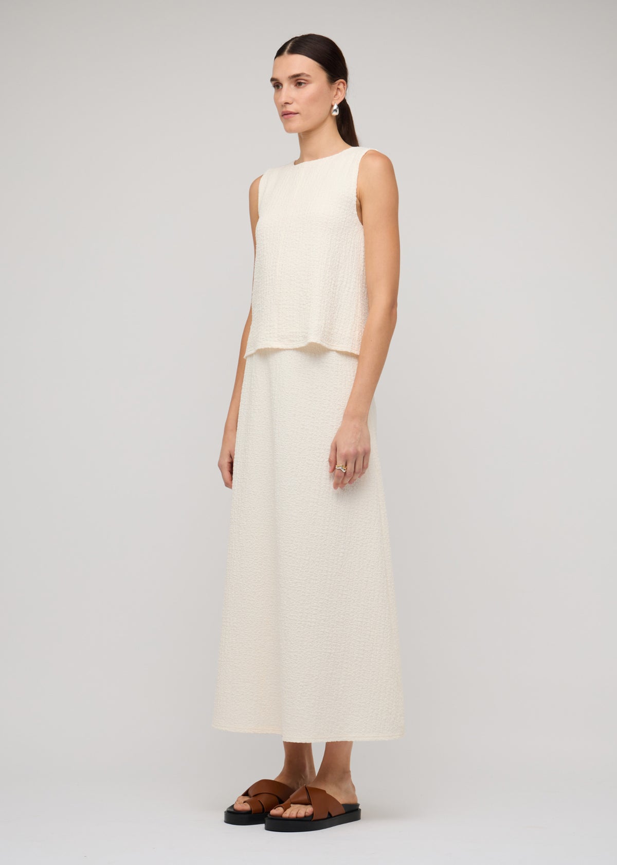 Model wearing Cream A-Line Midi Skirt, showing a midi length.