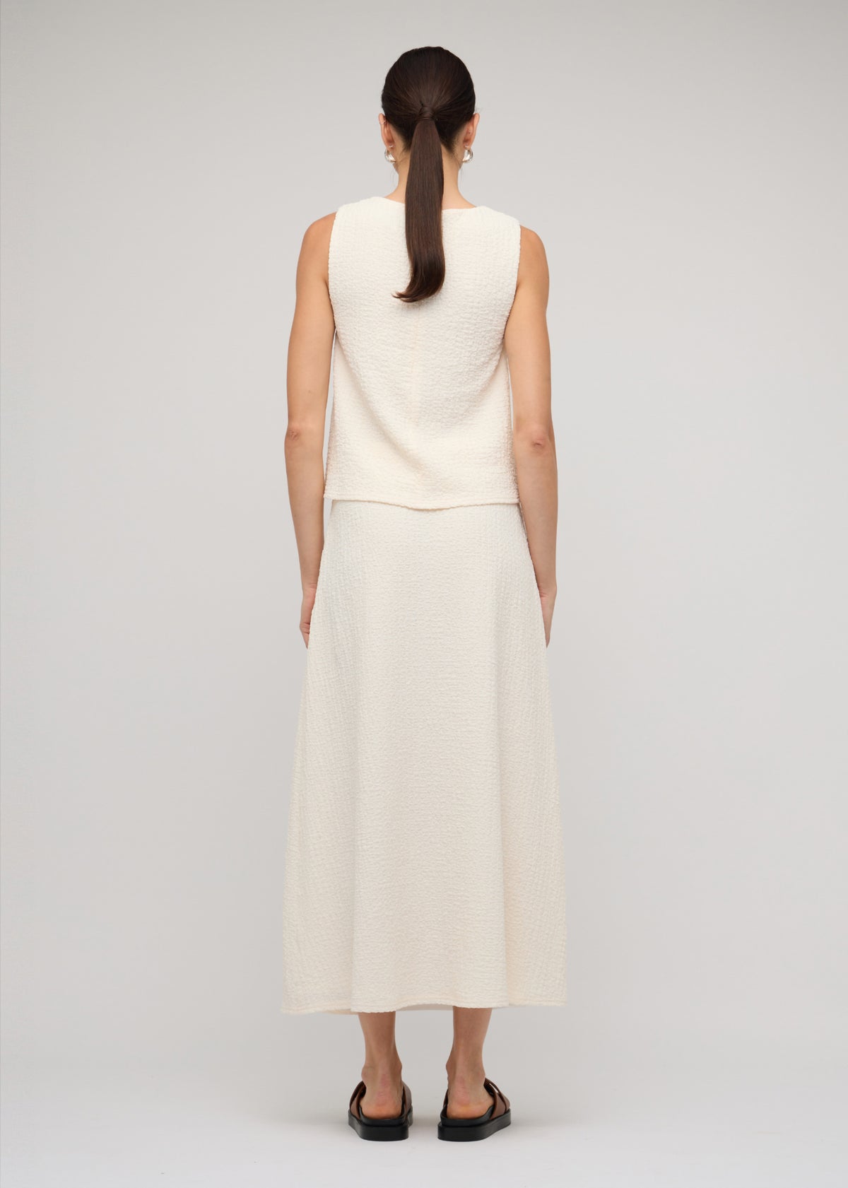 Back view of the Cream A-Line Midi Skirt with a midi length.