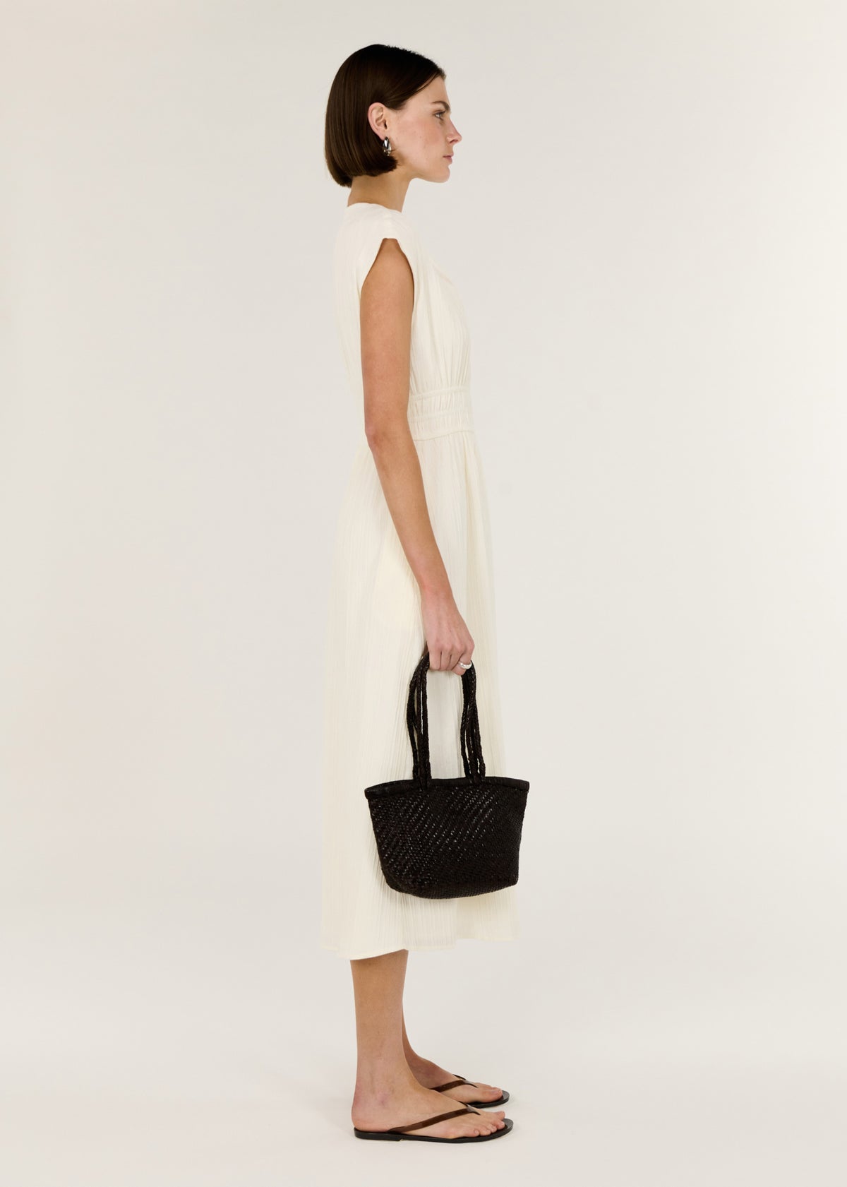 Side view of the Cream Cotton V-Neck Midi Dress, showing a vanilla colourway and soft cap sleeves.