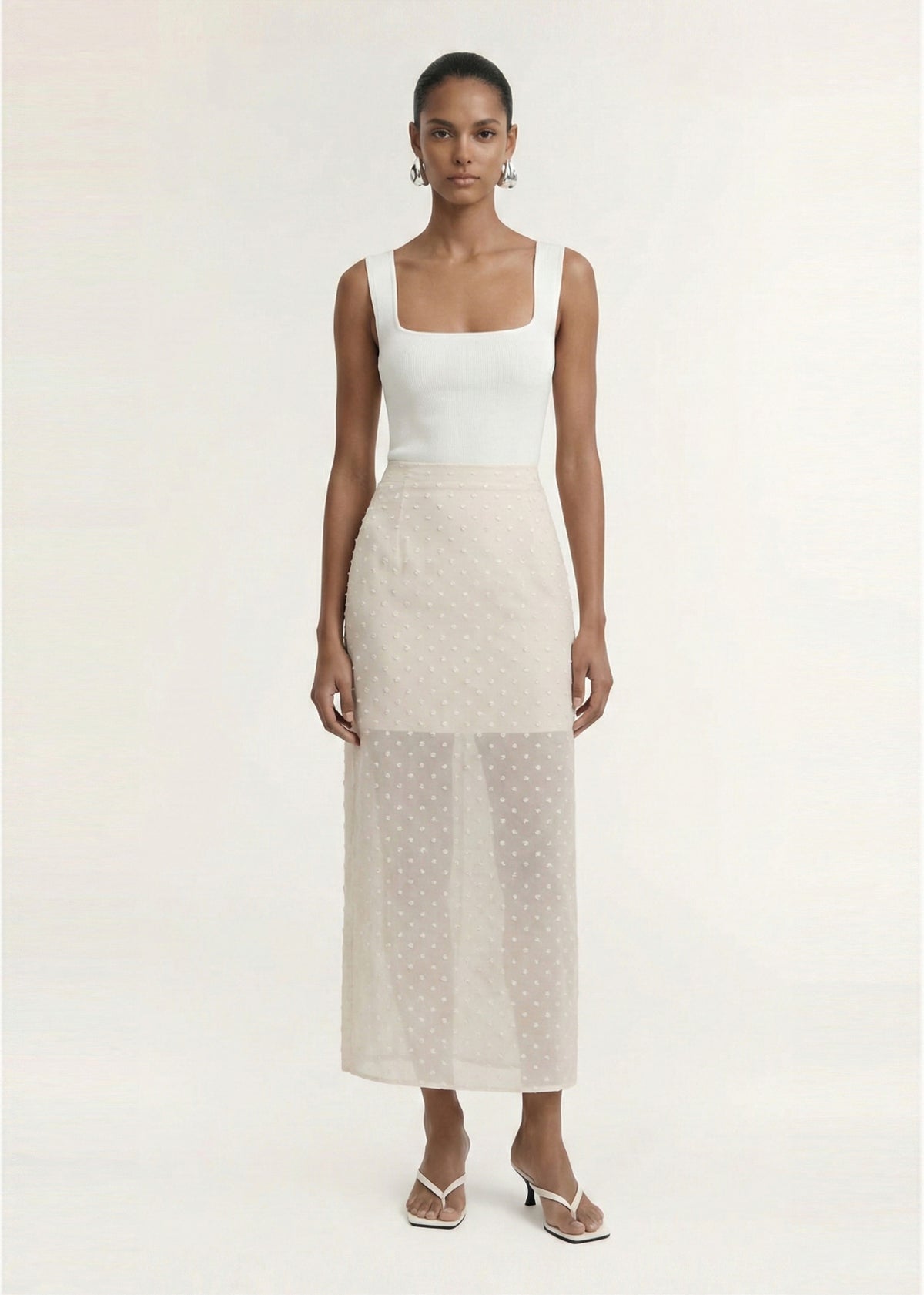 Model wearing Cream Embroidered Spot Sheer Layered Midi Skirt with a lightweight sheer dobby fabrication and a subtle spot texture.