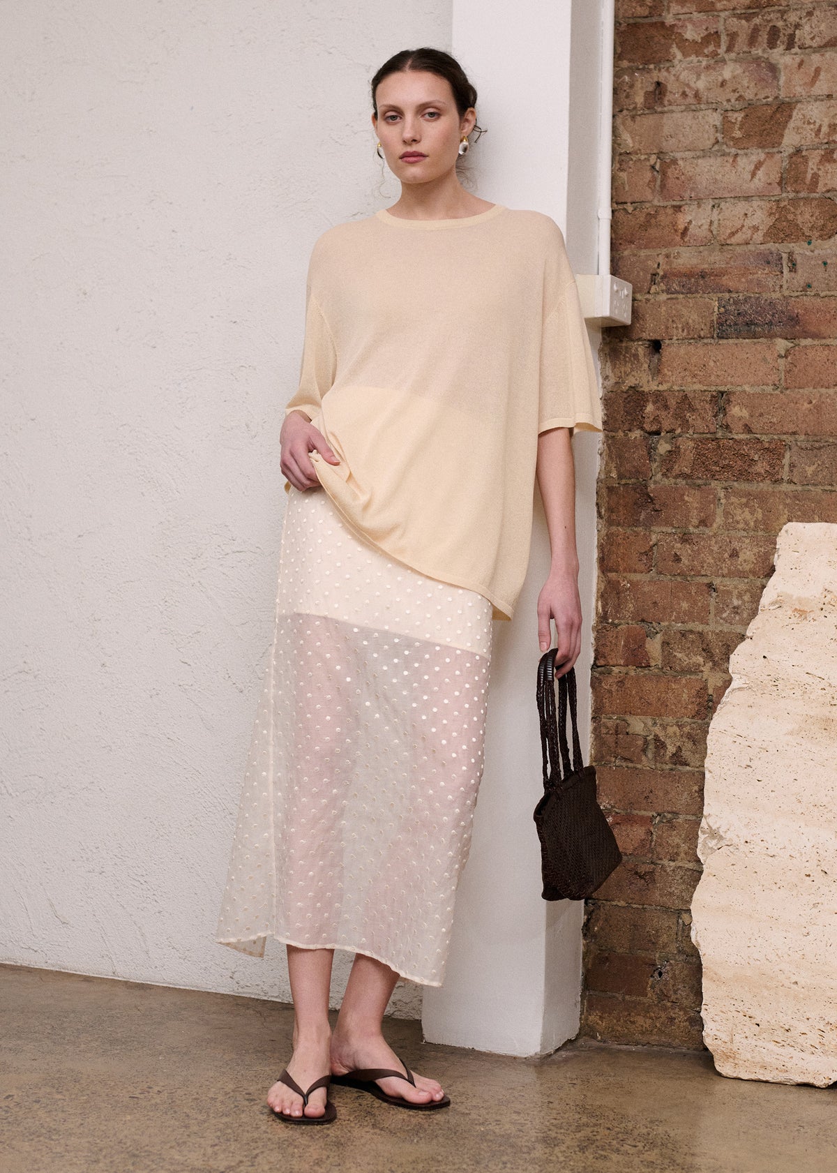 Model wearing Cream Embroidered Spot Sheer Layered Midi Skirt with a back zip closure and a lightweight sheer dobby fabrication.