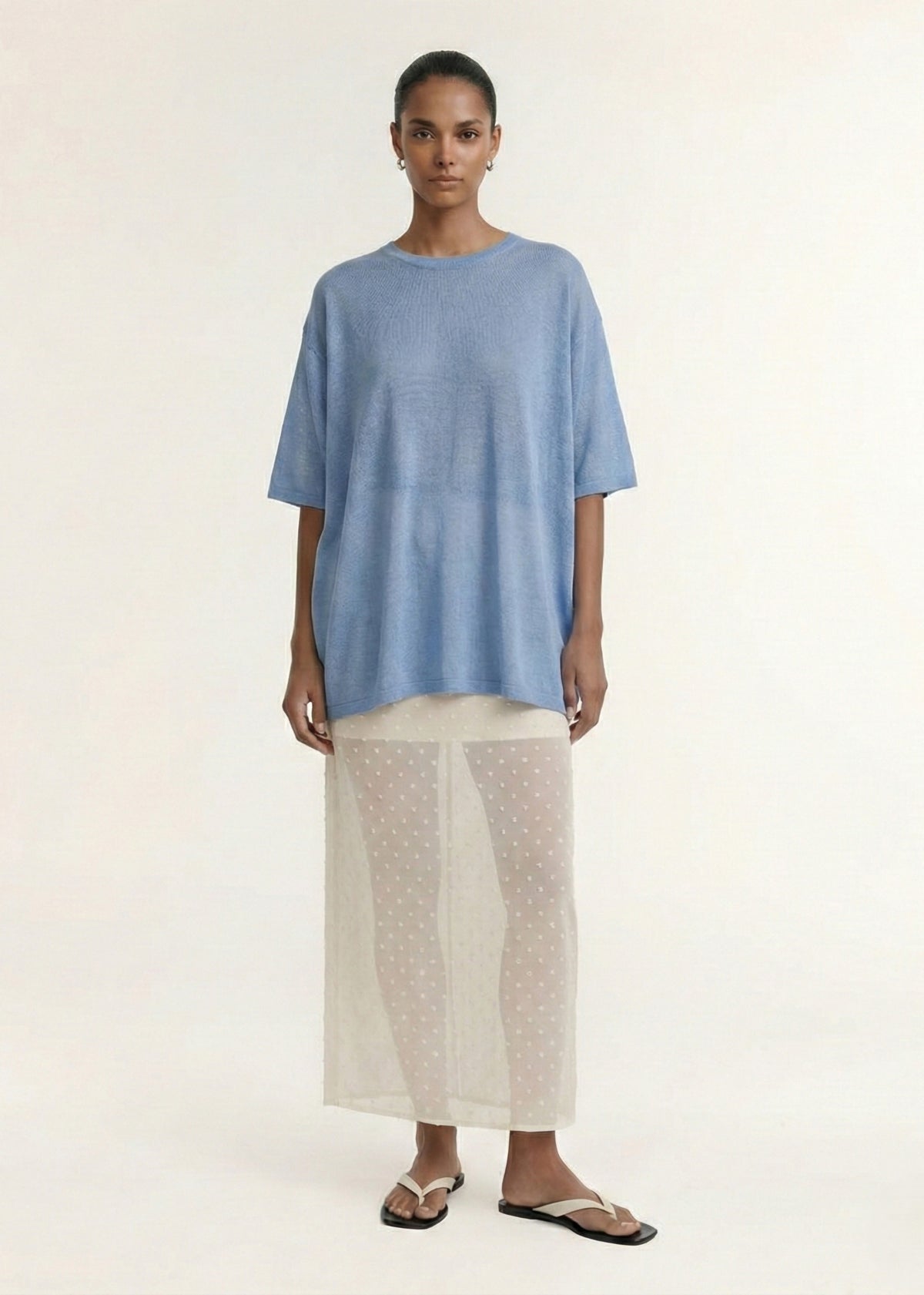 Model wearing Cream Embroidered Spot Sheer Layered Midi Skirt, showing a subtle spot texture and a fitted silhouette.