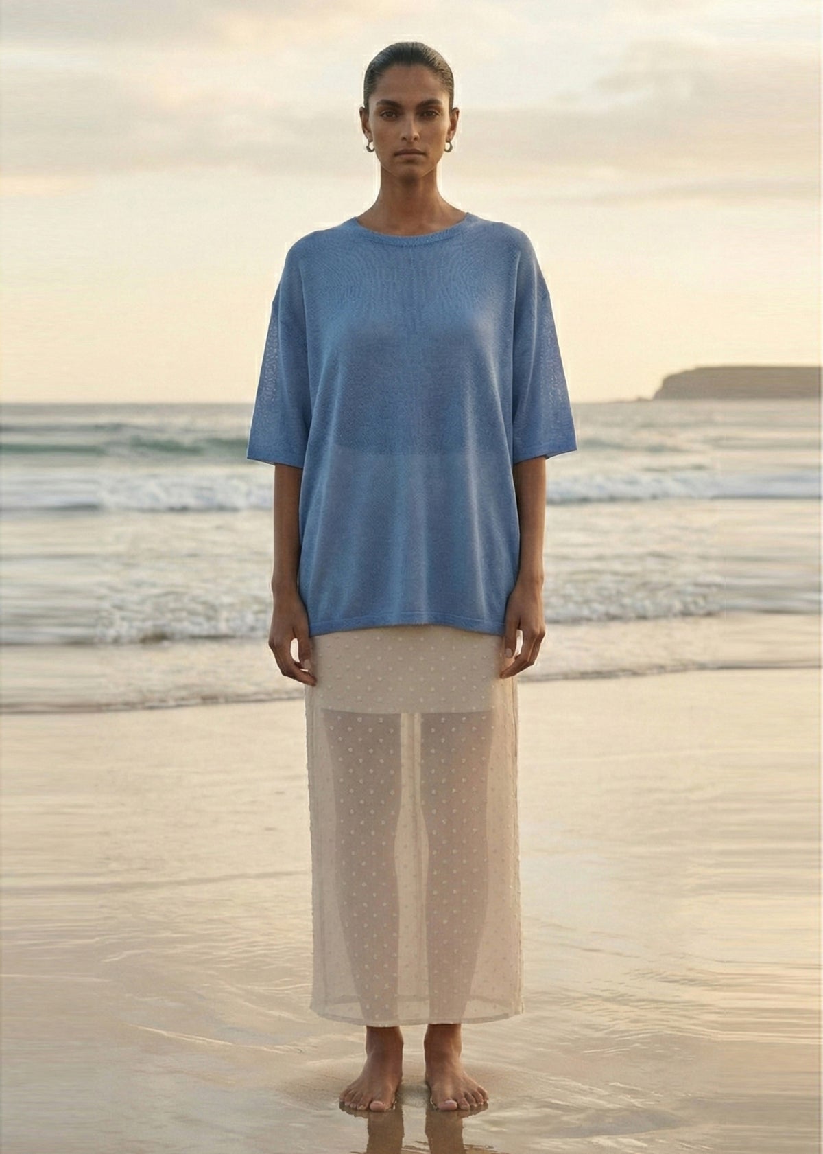 Model wearing Cream Embroidered Spot Sheer Layered Midi Skirt with a natural waist and a sheer layered finish.