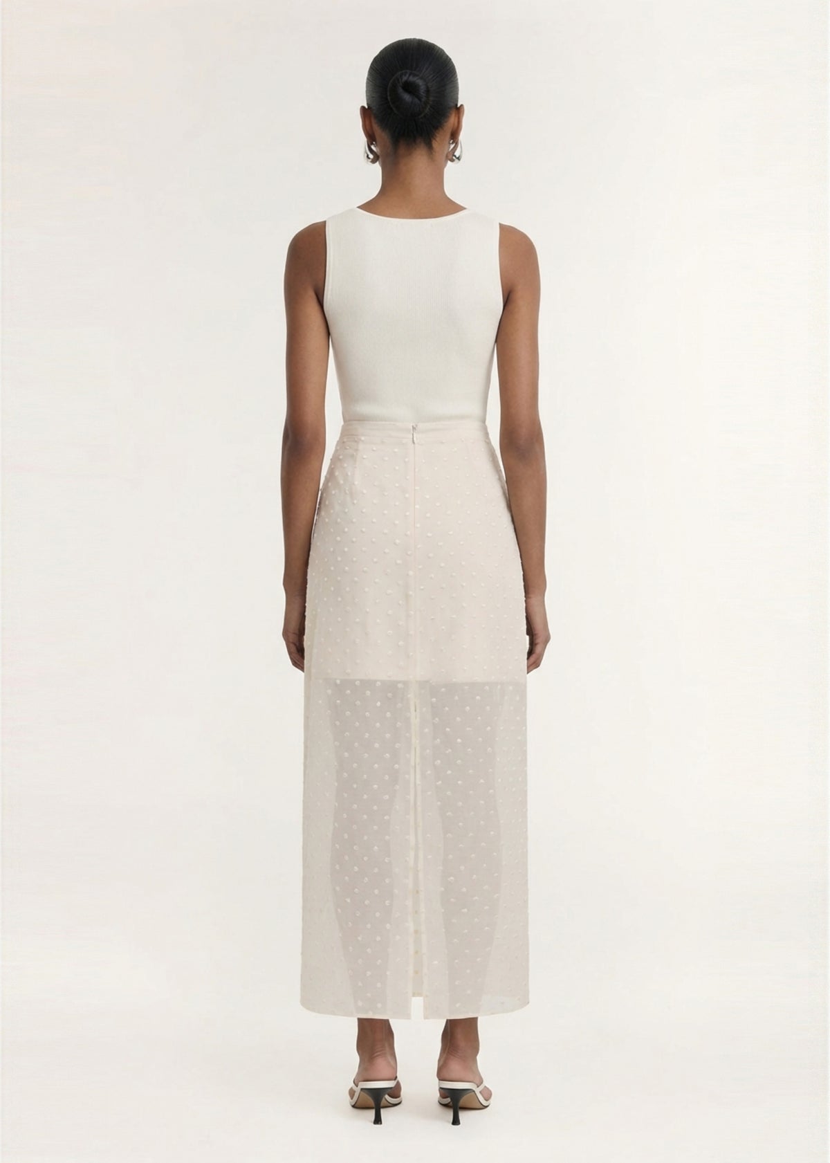 Back view of the Cream Embroidered Spot Sheer Layered Midi Skirt with a back zip closure and a lightweight sheer dobby fabrication.