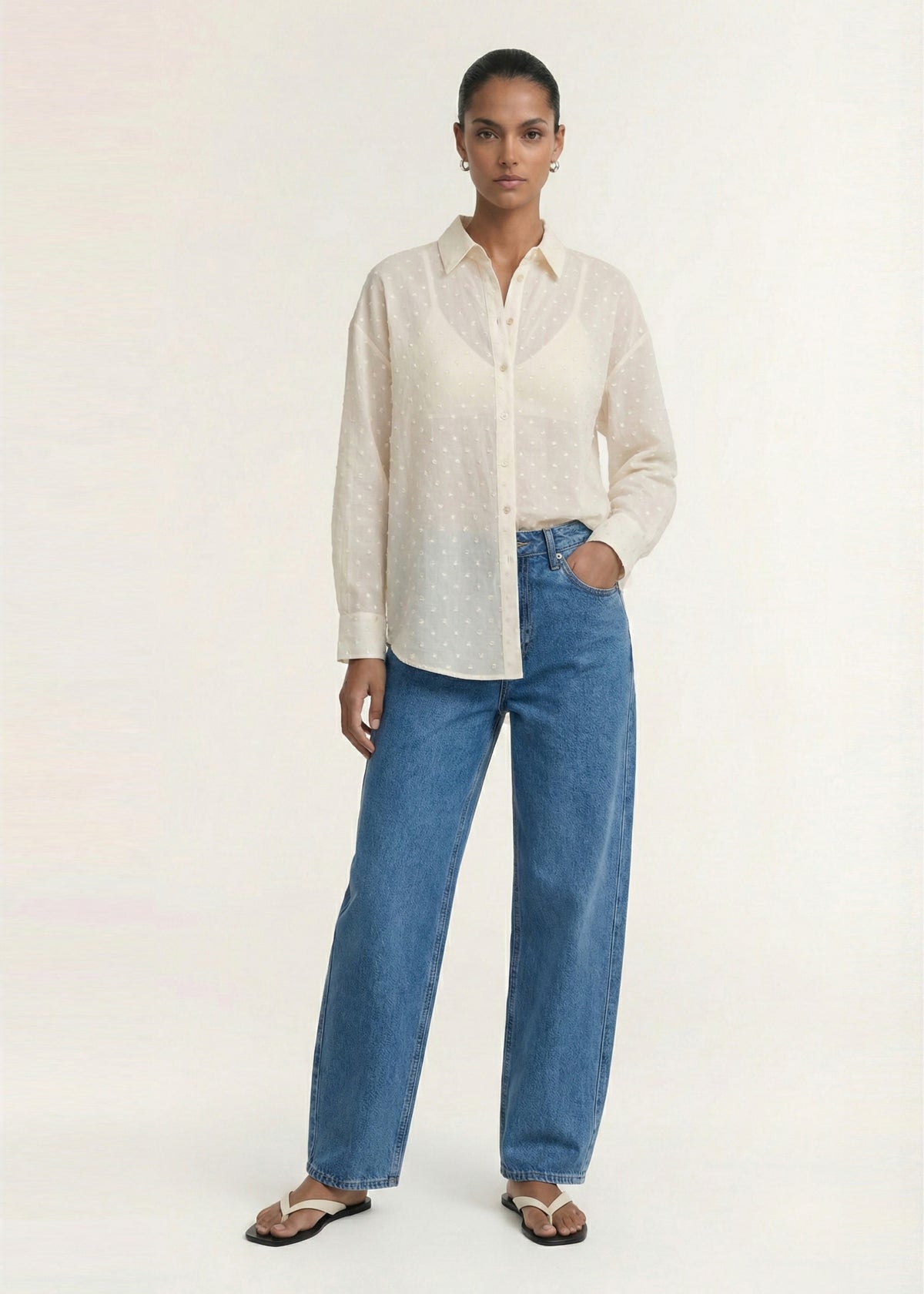 Model wearing Cream Embroidered Spot Sheer Oversized Shirt with a lightweight dobby fabrication and a subtle spot texture.