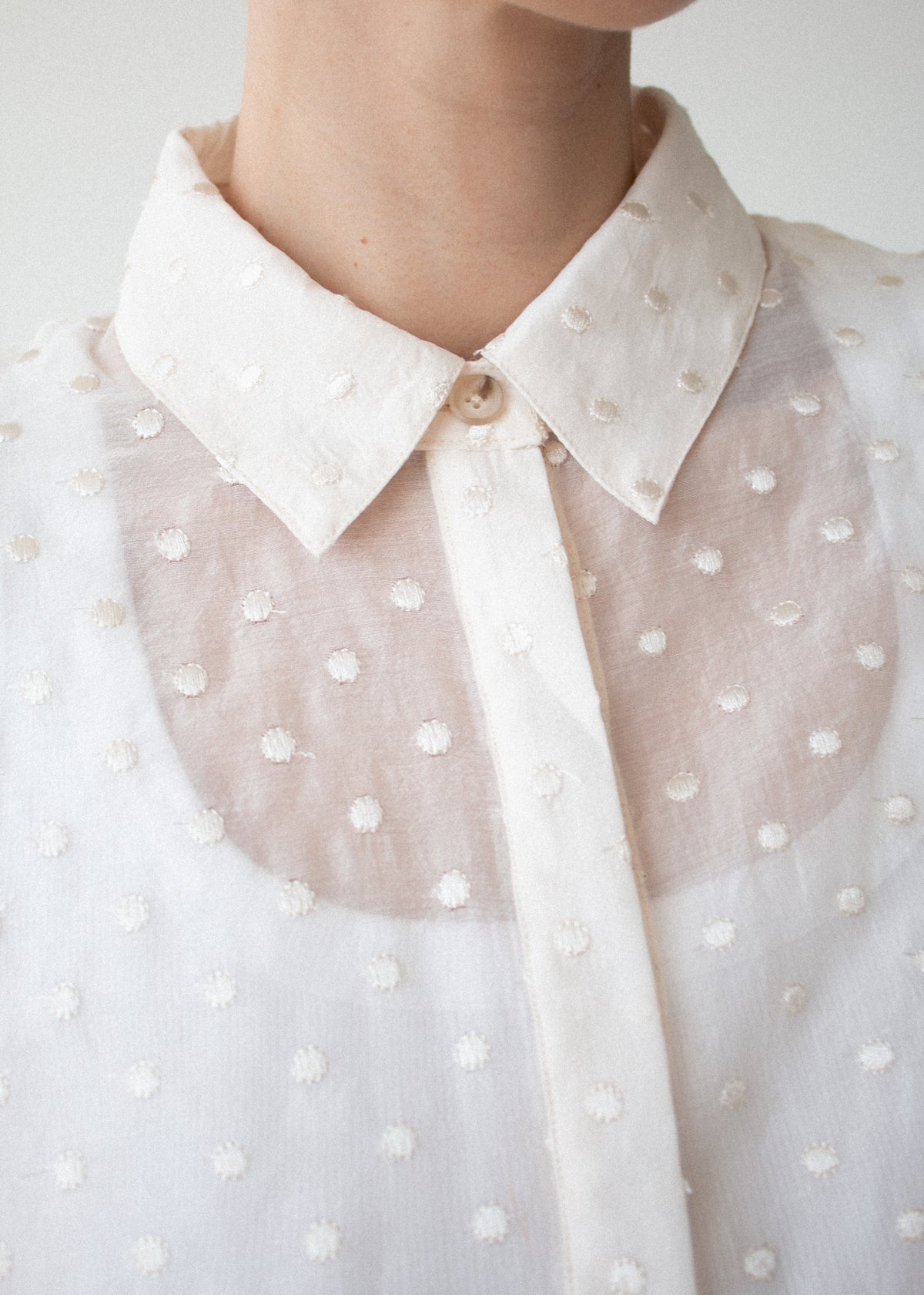 Close-up detail of the Cream Embroidered Spot Sheer Oversized Shirt, showing collar and button.