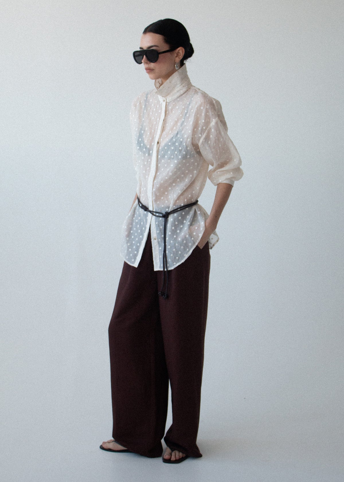 Side view of the Cream Embroidered Spot Sheer Oversized Shirt, showing an oversized silhouette and long sleeves with button cuffs.