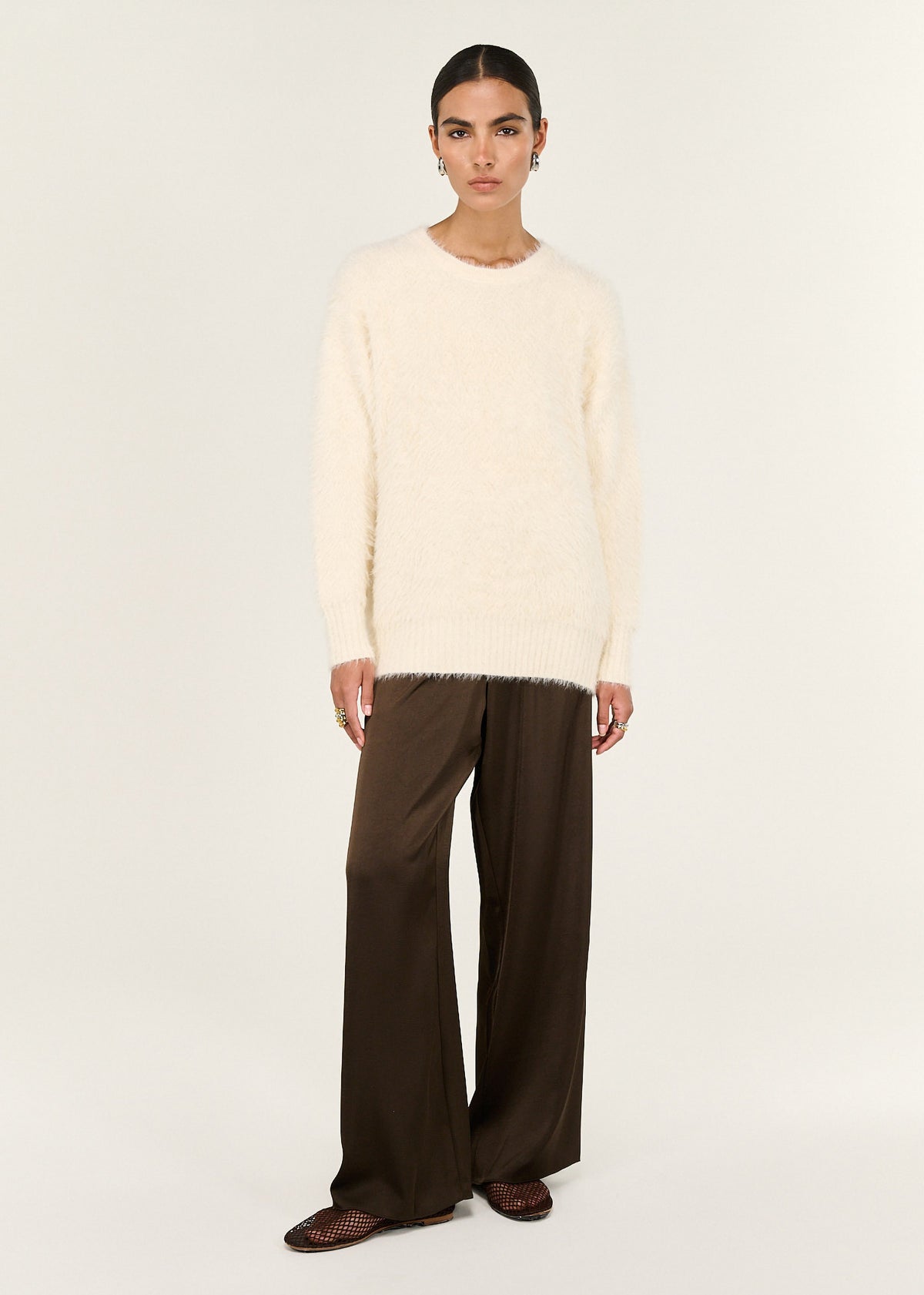 Model wearing Cream Fluffy Oversized Jumper with an oversized silhouette and a soft fluffy knit fabrication.