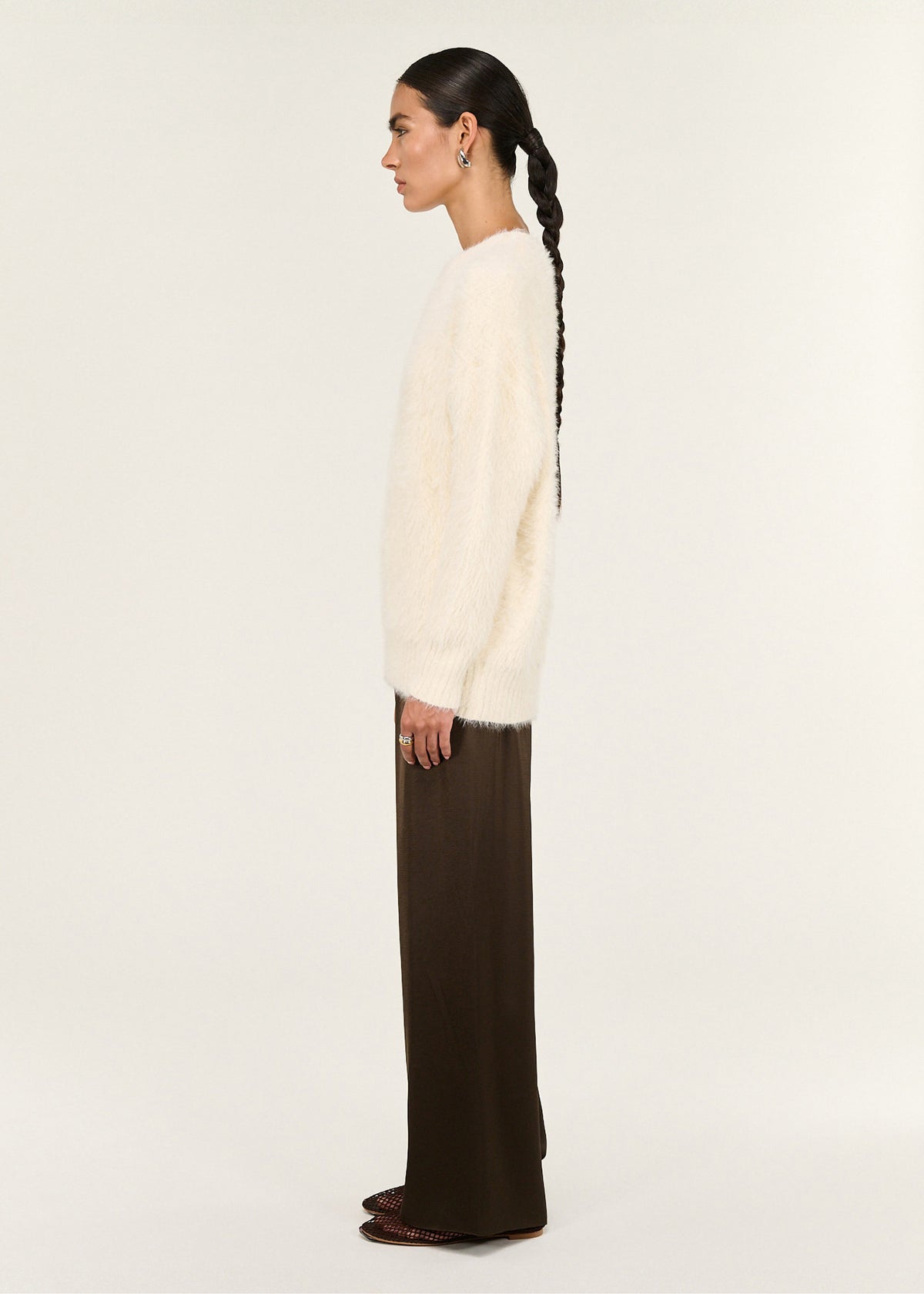 Side view of the Cream Fluffy Oversized Jumper, showing a ribbed cuffs and hem.