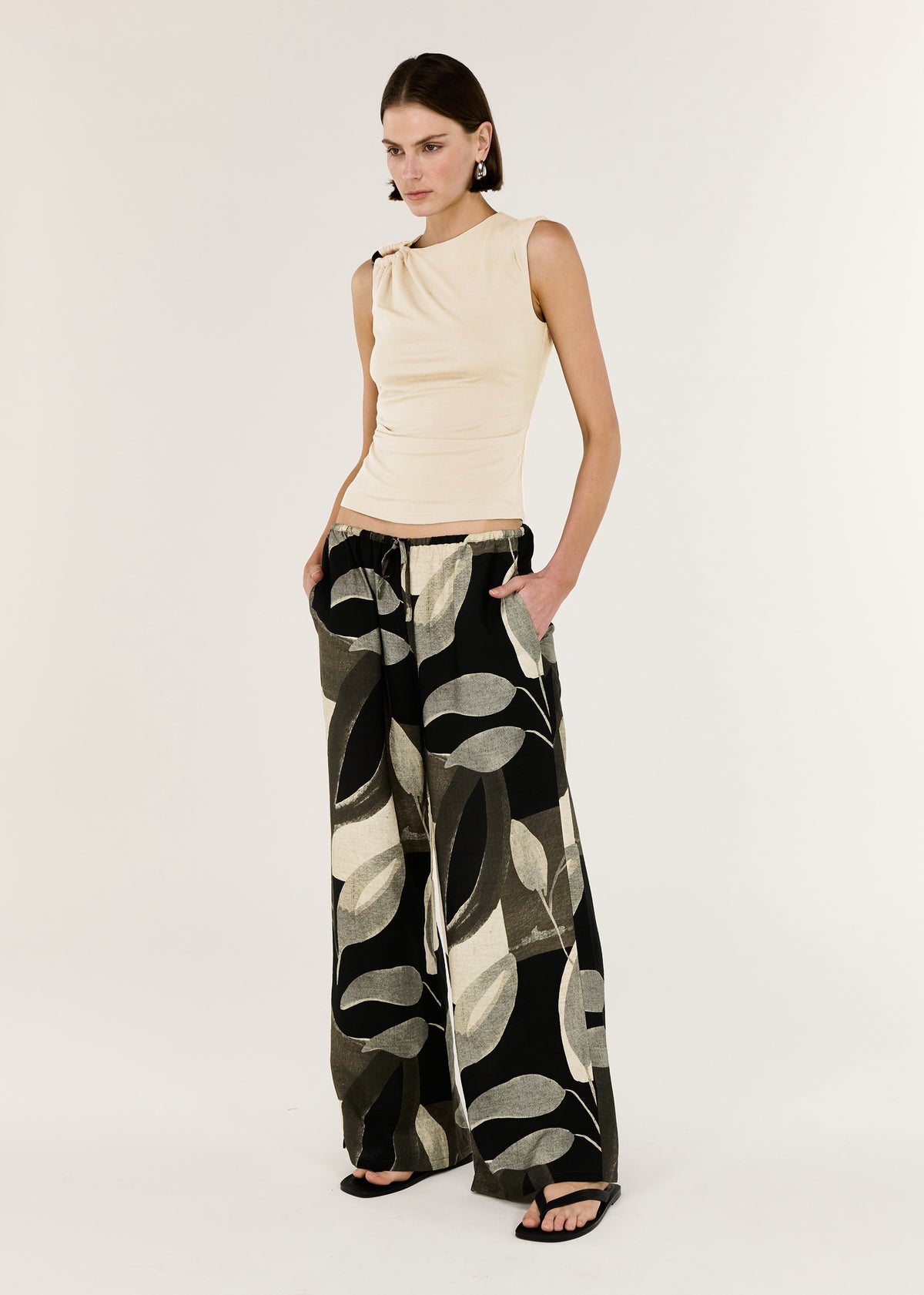 Model wearing Cream Ruched Slinky Tank, showing a soft stretch jersey fabrication and a fitted shape.
