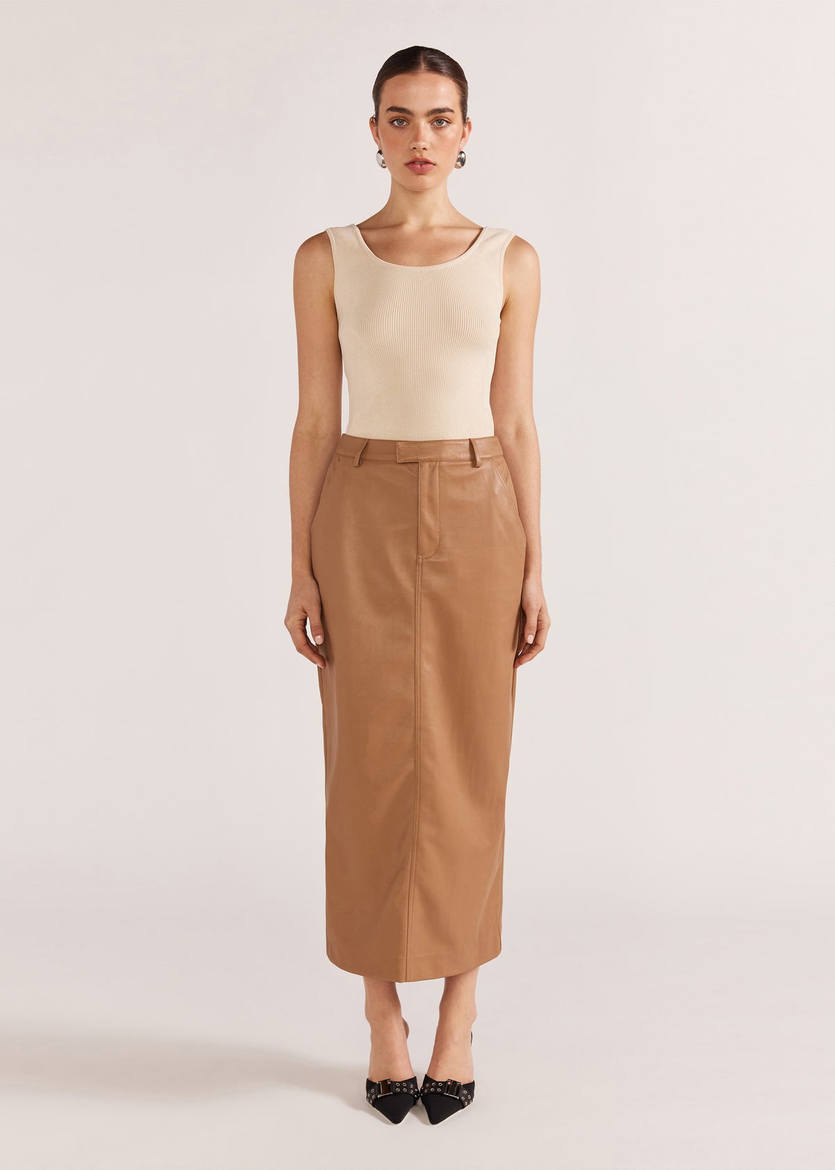 Model wearing Cynthia Pu Midi Skirt with a soft PU fabric and a back vent.