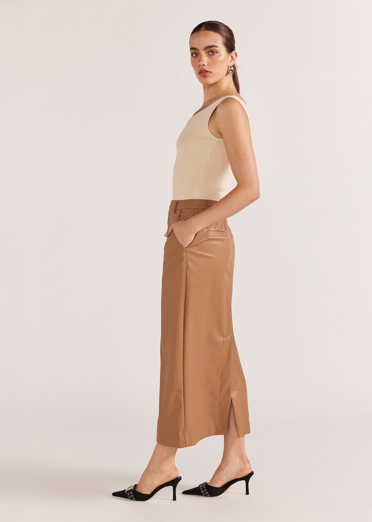 Side view of the Cynthia Pu Midi Skirt, showing a back vent and belt loops.