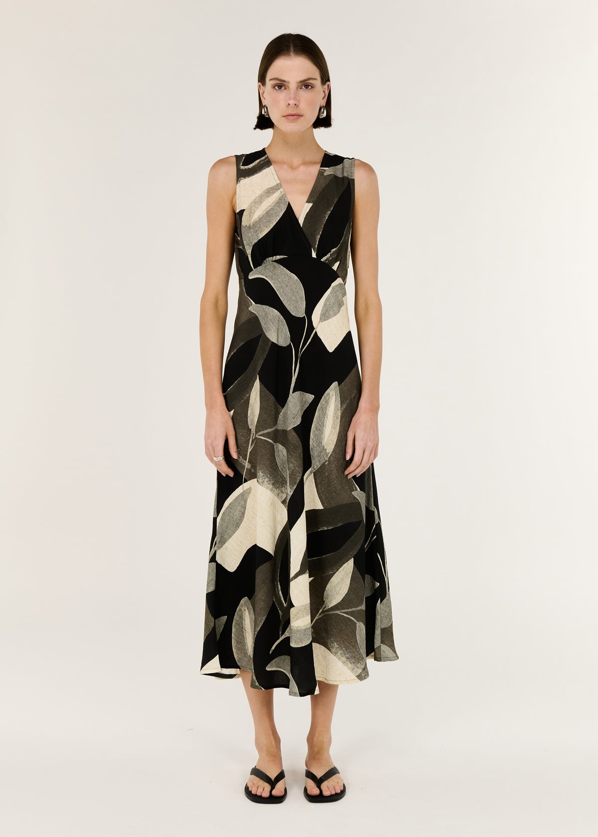 Model wearing Dark Leaf Bias Midi Dress, showing a sleeveless cut and an adjustable back waist tie.