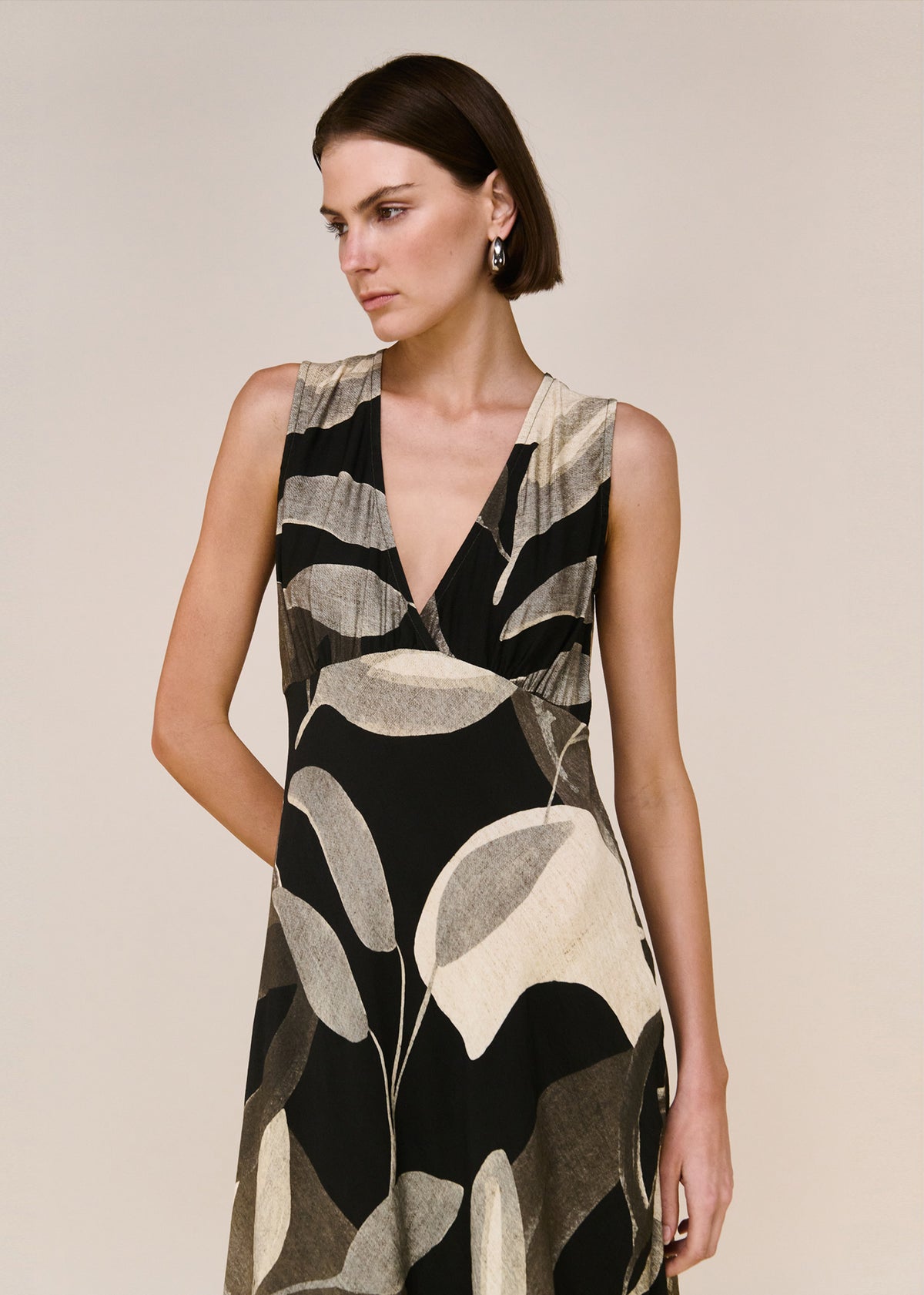 Close-up of the Dark Leaf Bias Midi Dress, showing a soft V-neckline and a sleeveless cut.