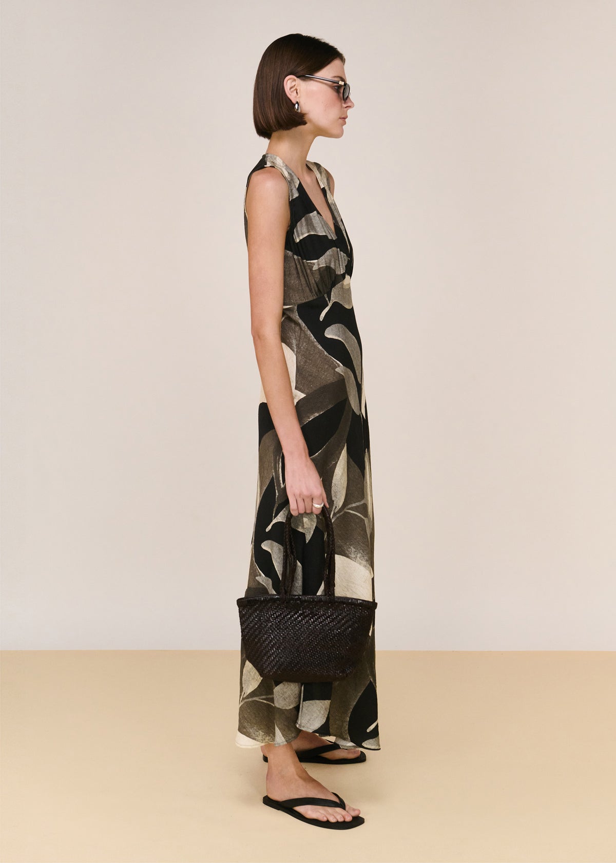 Side view of the Dark Leaf Bias Midi Dress, showing a sleeveless cut and an adjustable back waist tie.
