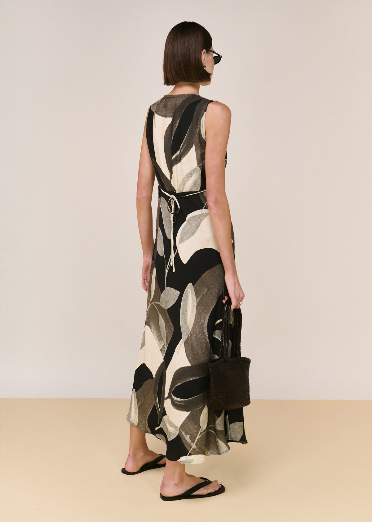 Back view of the Dark Leaf Bias Midi Dress with an adjustable back waist tie and a bias-cut silhouette.