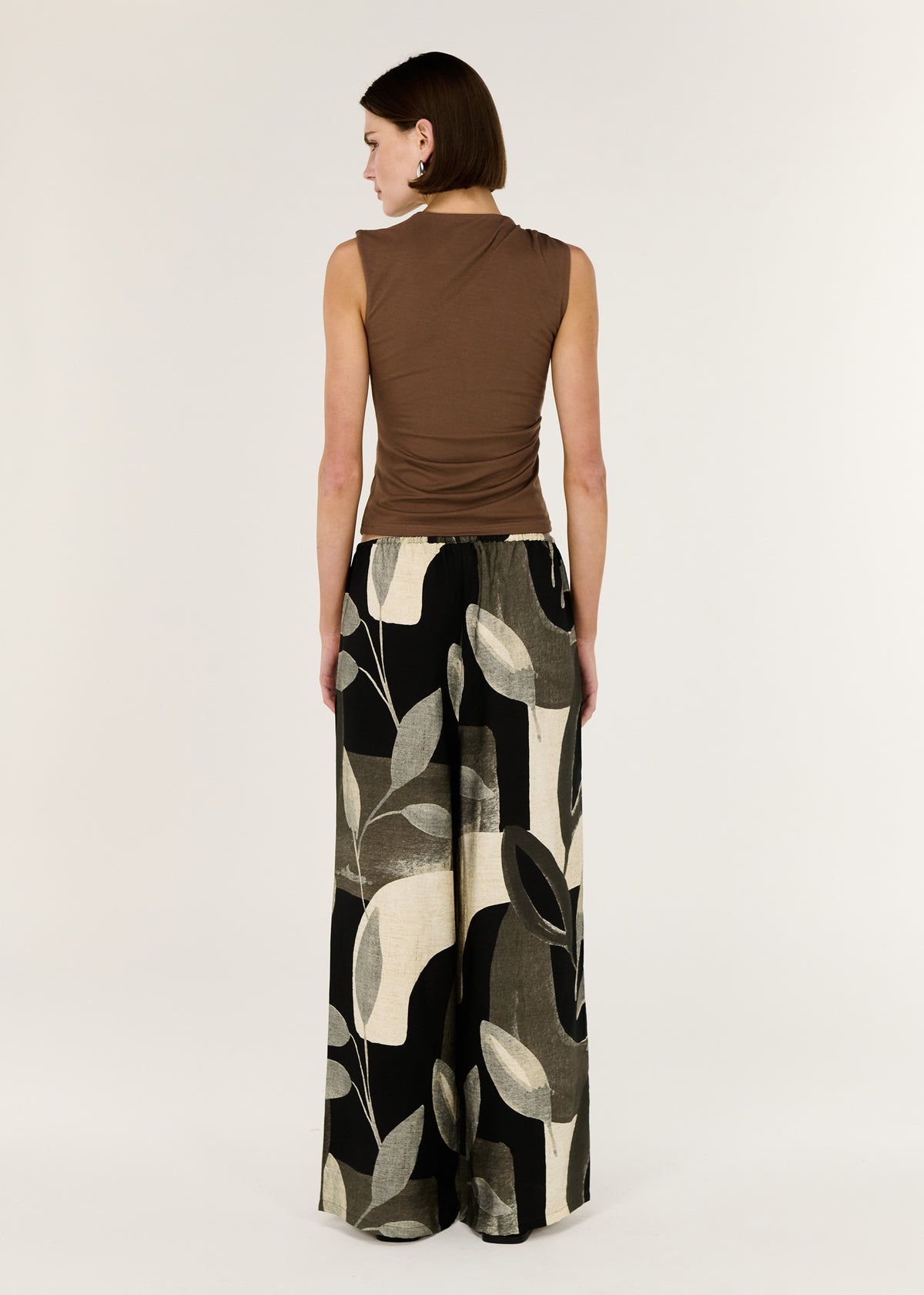 Back view of the Dark Leaf Relaxed Wide-Leg Pant with a relaxed pant silhouette and a fluid drape through the leg.