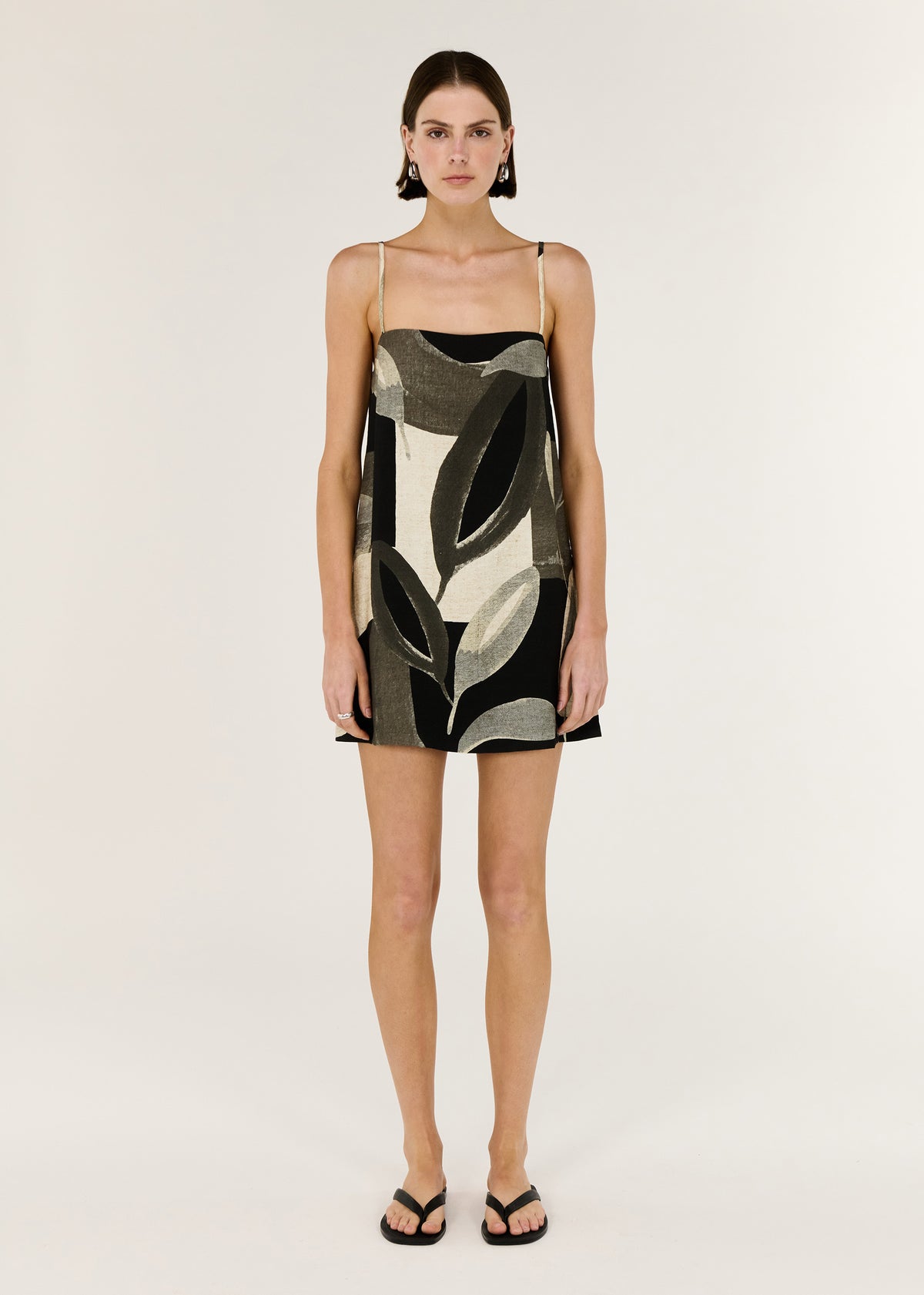 Model wearing Dark Leaf Shift Mini Dress with a mini Length and a statement Leaf Garden print.