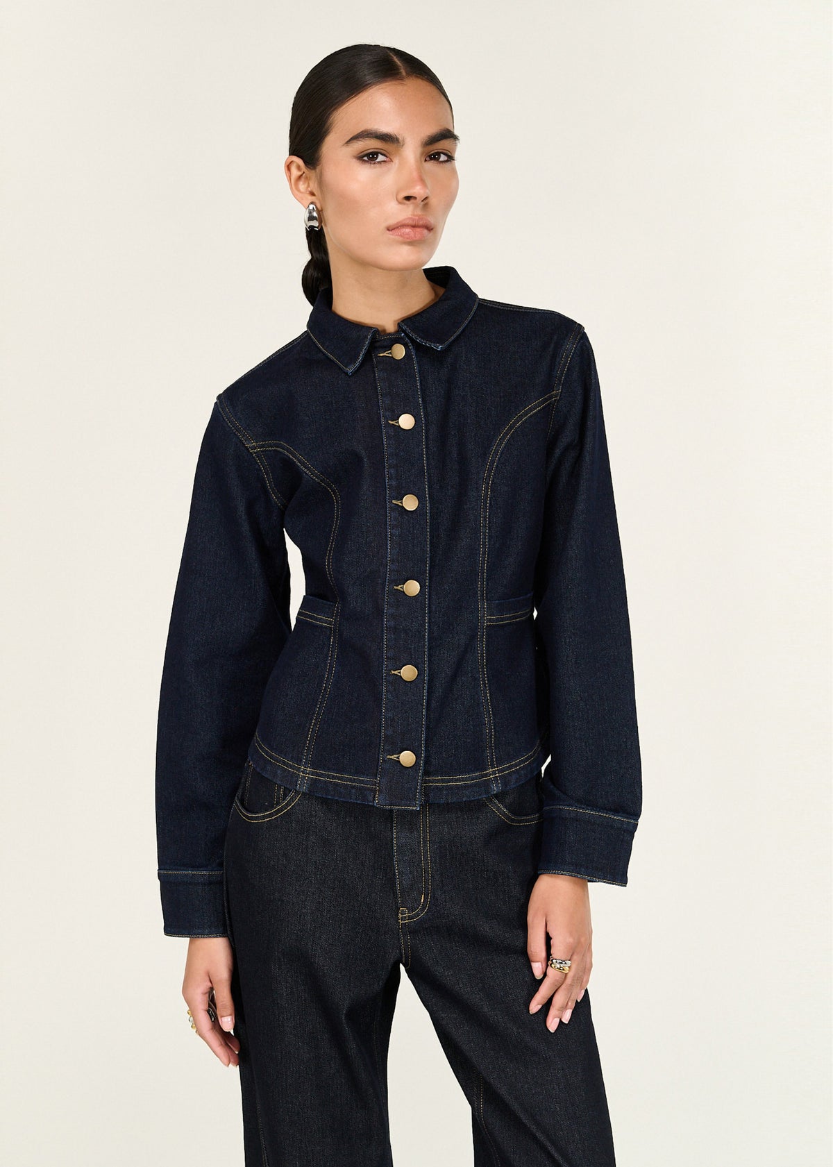 Close-up of the Dark Wash Fitted Denim Shirt Jacket, showing a collared neckline and a button-through front closure.