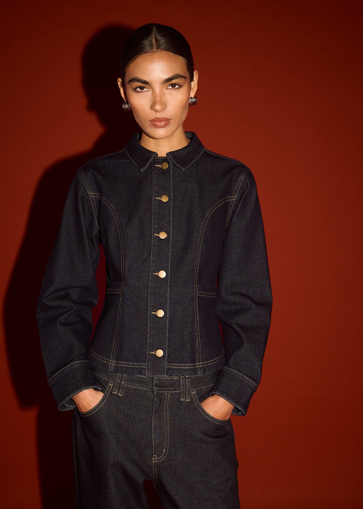 Model wearing Dark Wash Fitted Denim Shirt Jacket, showing a contrast topstitch detailing and a dark indigo wash.