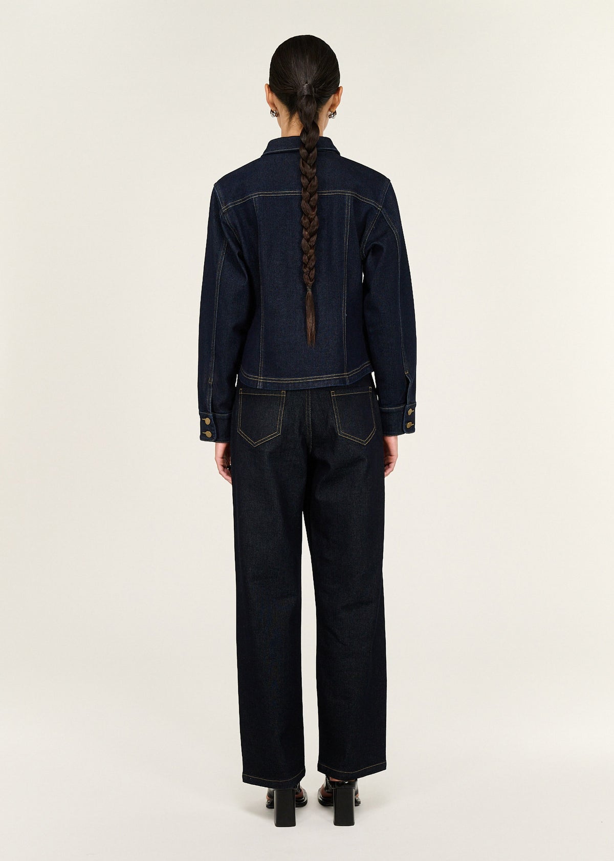 Back view of the Dark Wash Fitted Denim Shirt Jacket with a button-through front closure and long sleeves with button cuffs.