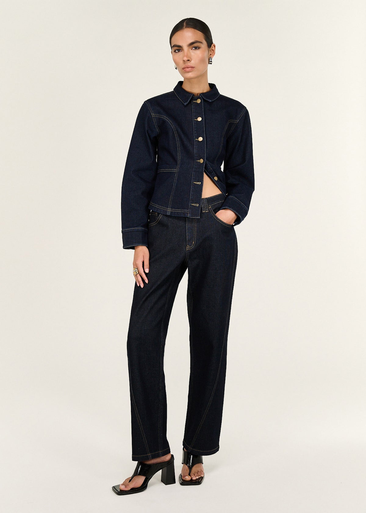 Model wearing Dark Wash Straight Leg Jeans with a mid-rise waist and a straight leg silhouette.