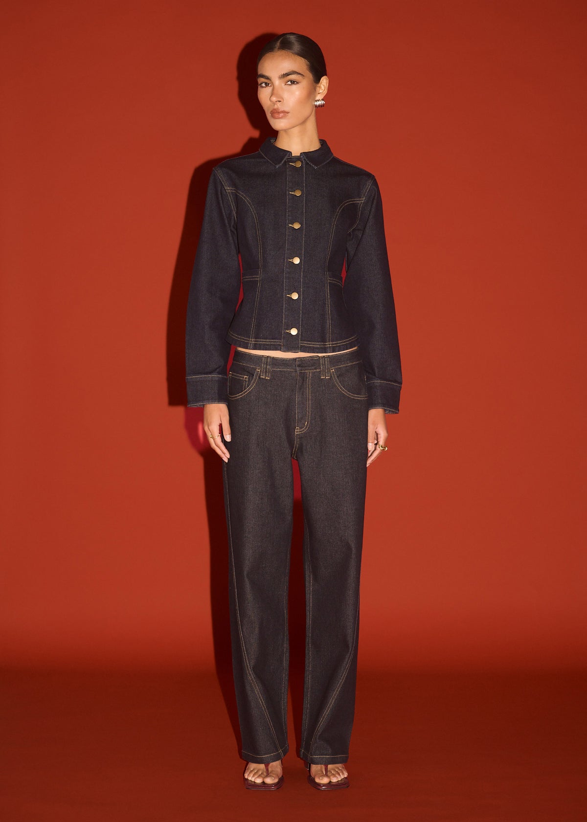 Model wearing Dark Wash Straight Leg Jeans, showing a contrast topstitch detailing and a dark indigo wash.