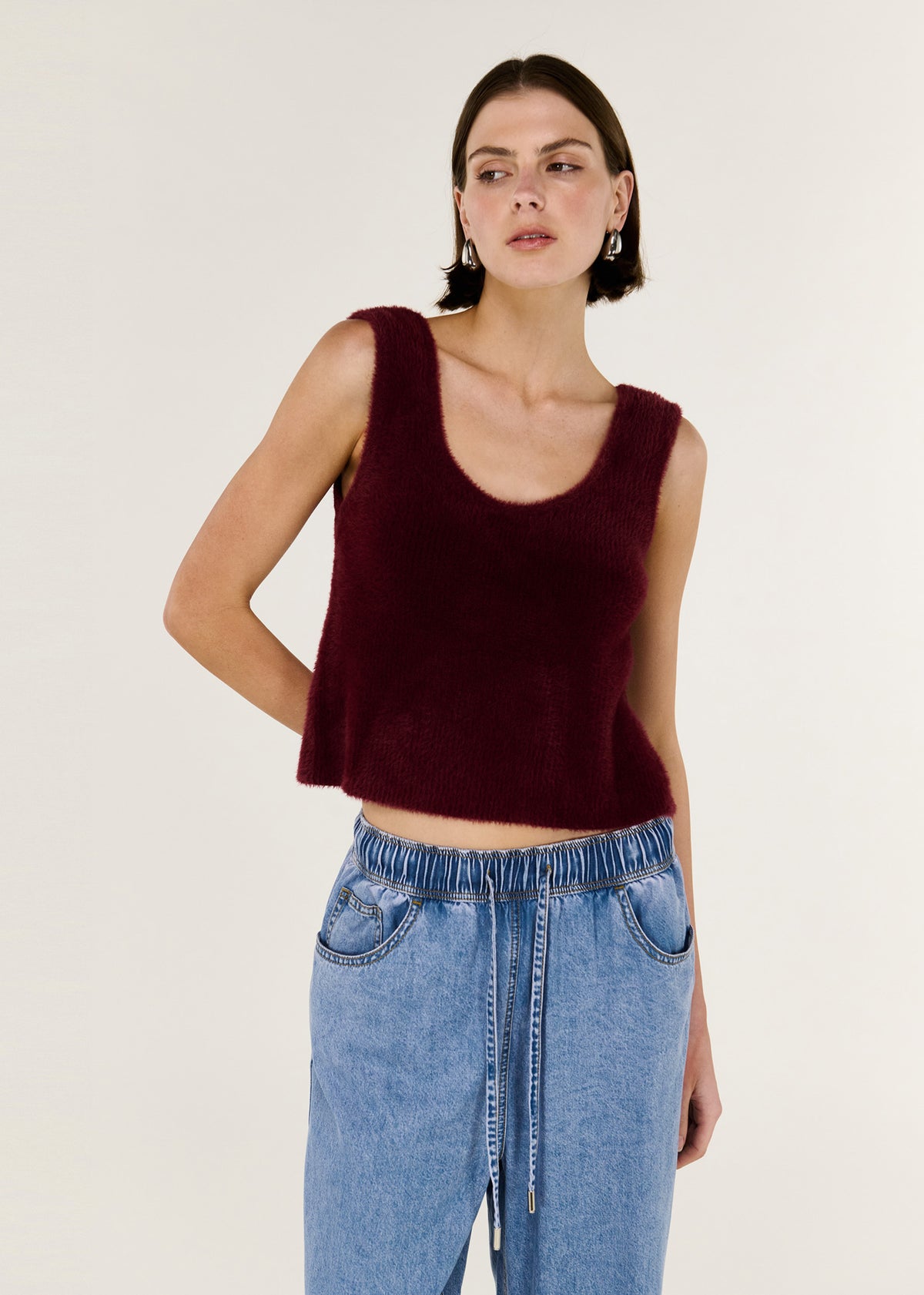 Model wearing Deep Red Plush Cotton Knit Tank with a sleeveless cut and a soft, fluffy cotton texture.