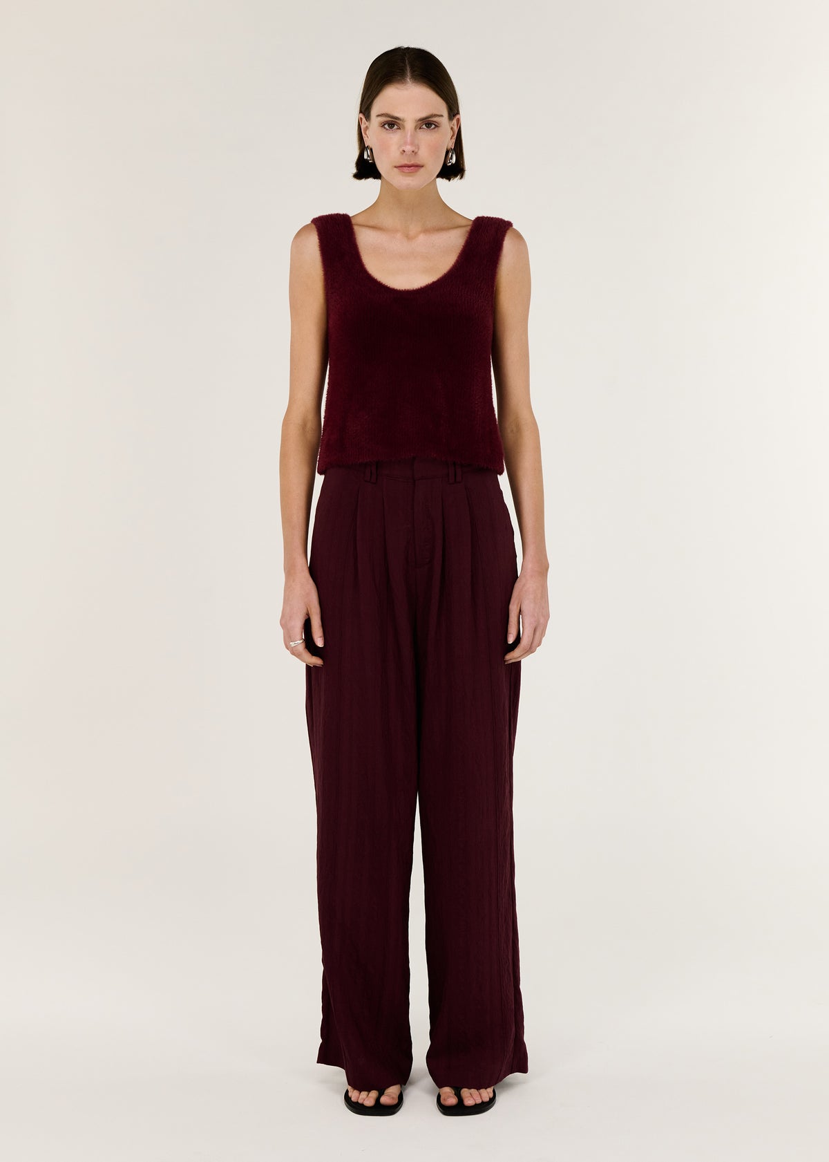 Model wearing Deep Red Plush Cotton Knit Tank, showing an easy layering essential and a colour: Shiraz.