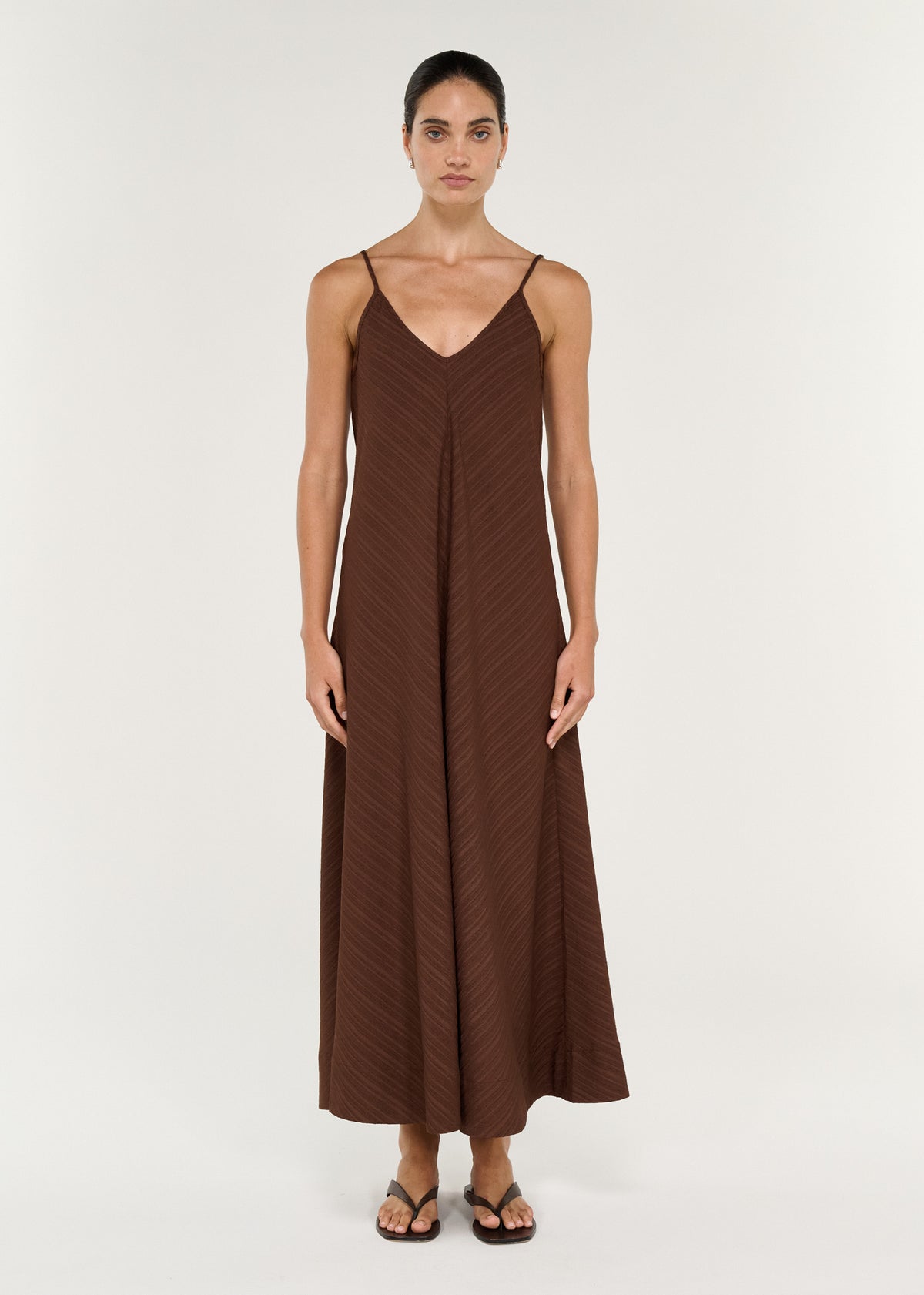 Textured Maxi Dress in Chocolate featuring a V-neckline and thin adjustable straps on a model.