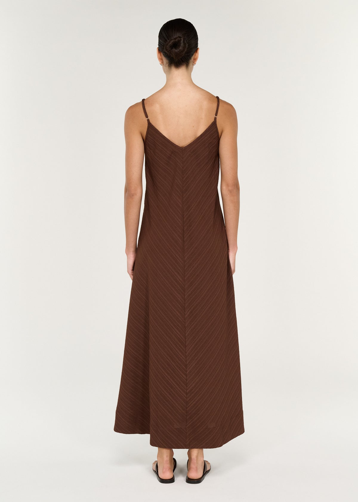 Textured Maxi Dress in Chocolate, showcasing the back view with adjustable straps and flowing silhouette.