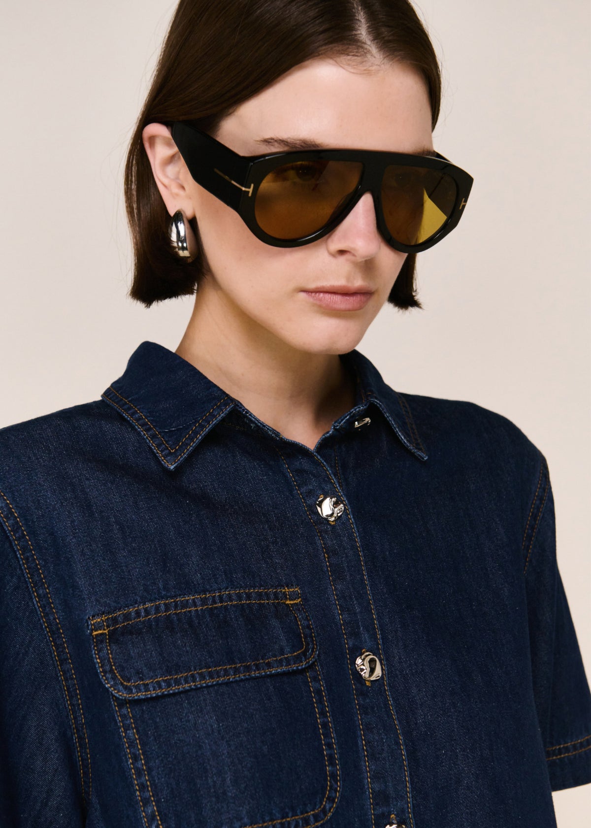 Close-up detail of the Denim Cropped Short-Sleeve Shirt, showing collar and buttons.