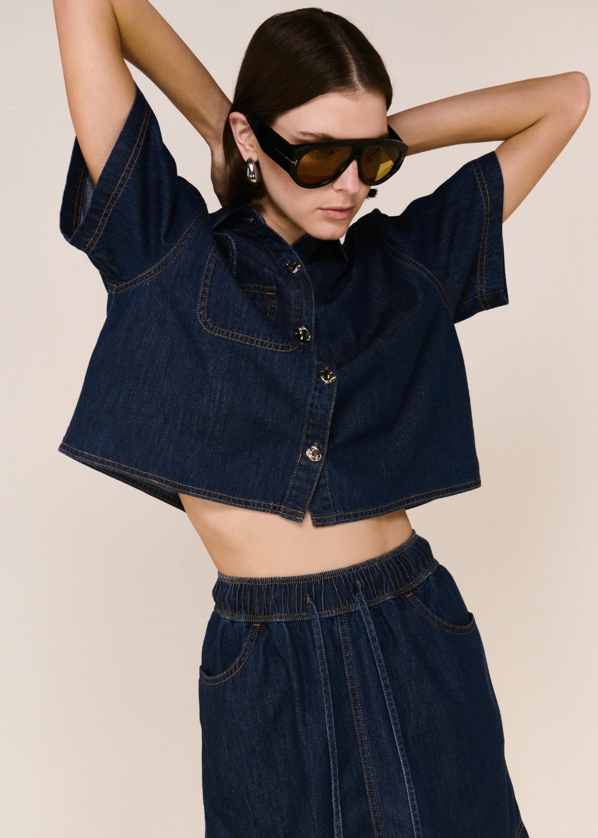Close-up of the Denim Elasticated Mini Skirt, showing a structured indigo denim and a high-rise fit.