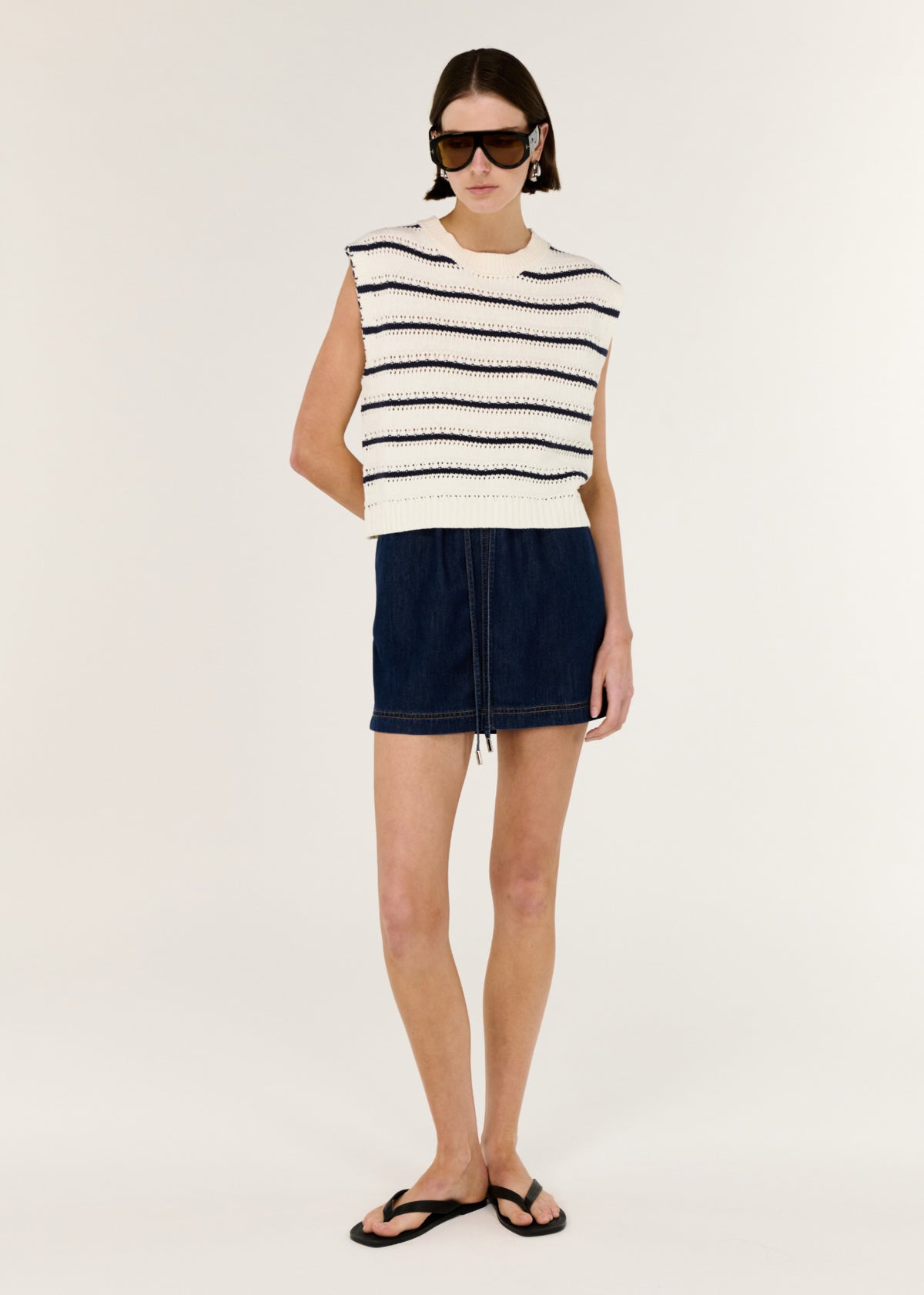 Model wearing Denim Elasticated Mini Skirt, showing a mini length and a classic, easy-to-style silhouette.