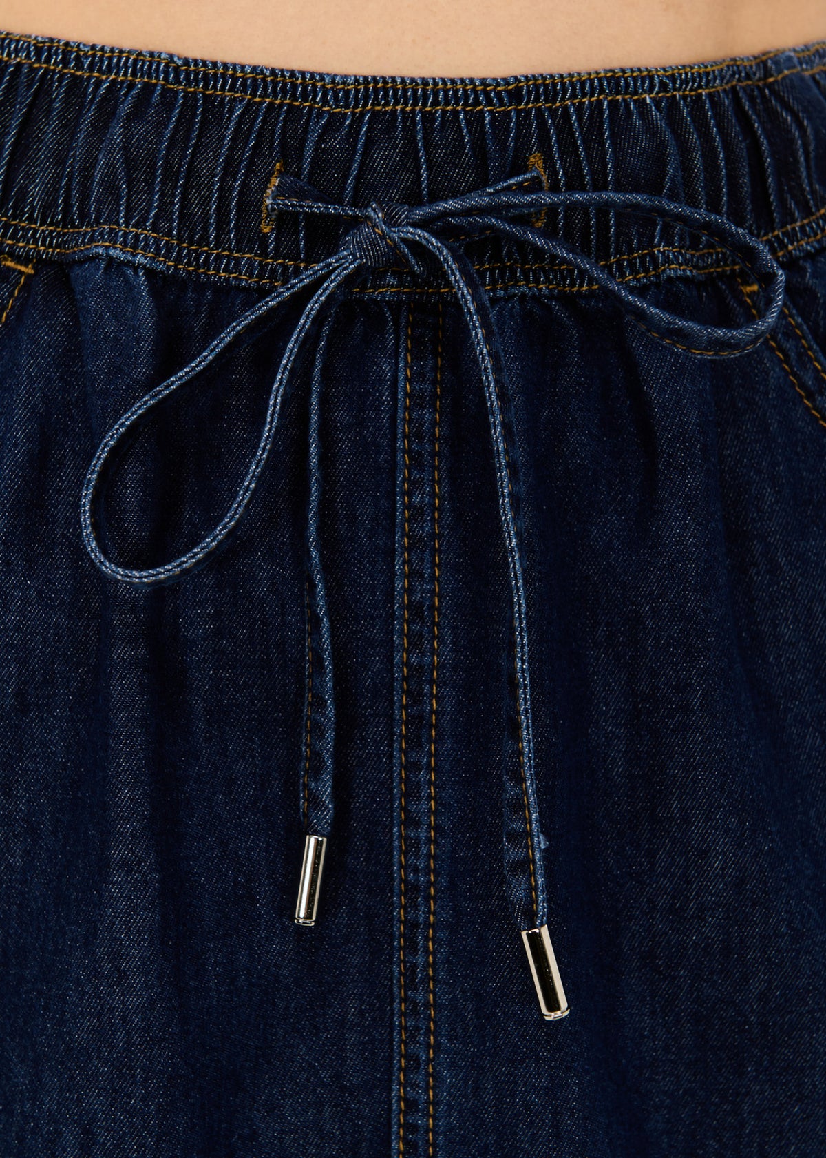 Close-up detail of the Denim Elasticated Mini Skirt, showing drawstring waistband.
