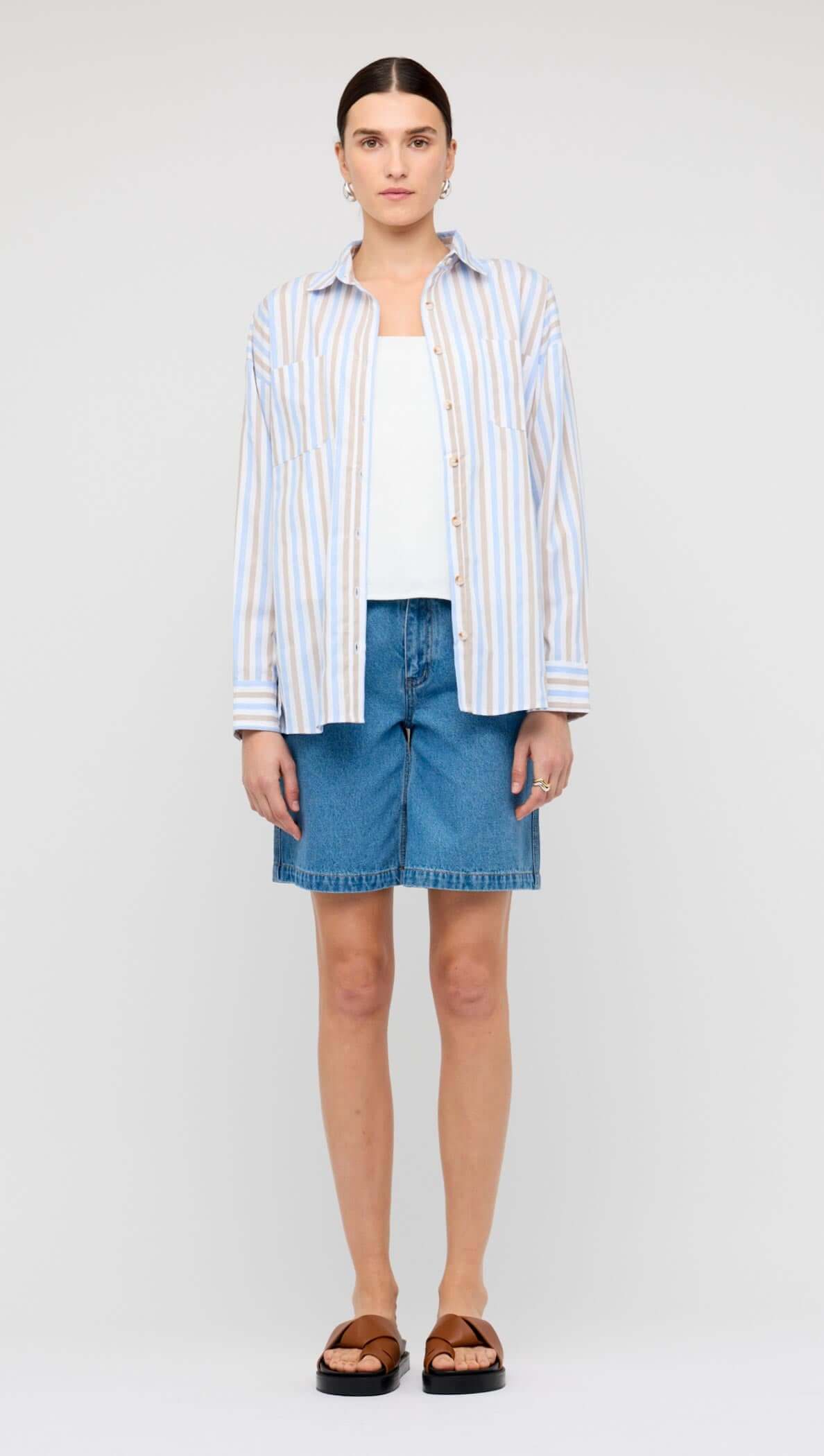 Model wearing Denim Mid-Rise Shorts paired with a floral top for a stylish summer look.