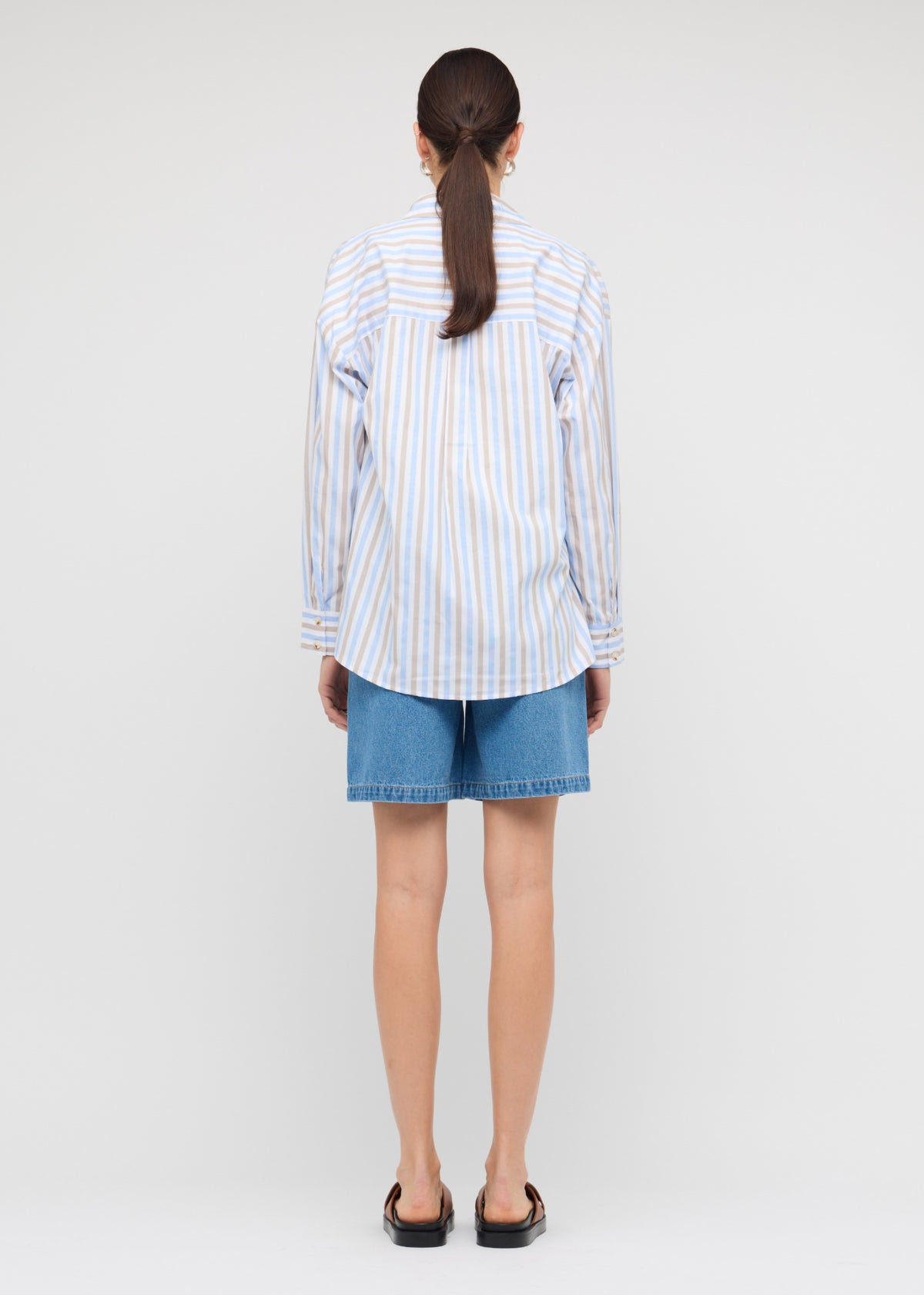 Back view of the Denim Mid-Rise Shorts with a mid-rise fit and a relaxed straight-leg silhouette.