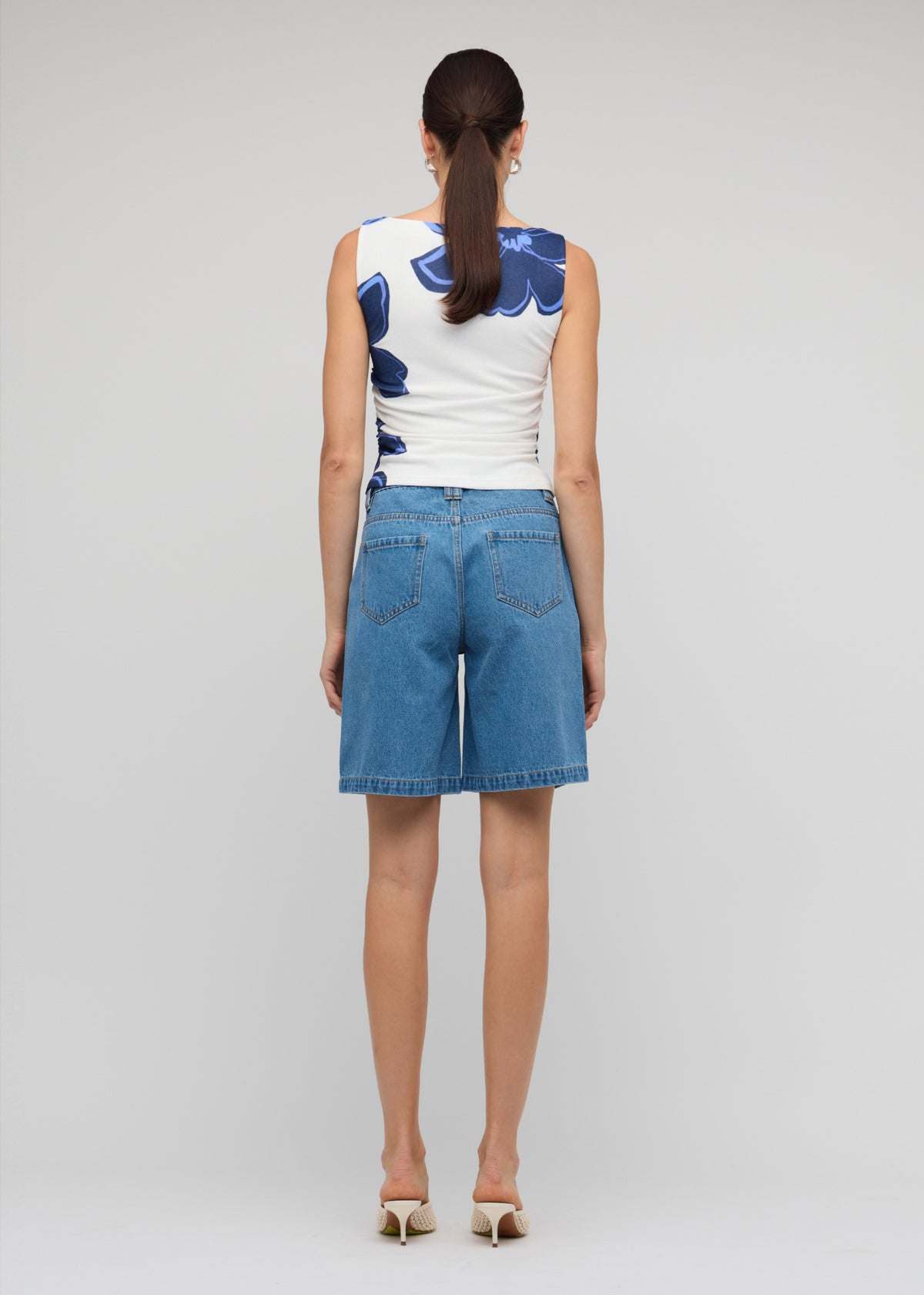 Back view of the Denim Mid-Rise Shorts, showing a mid-rise fit and a relaxed straight-leg silhouette.