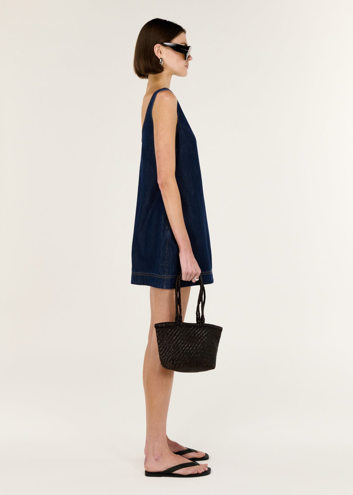Side view of the Denim Mini Dress with Scoop Back, showing a soft, lightweight denim feel and an easy pull-on style.
