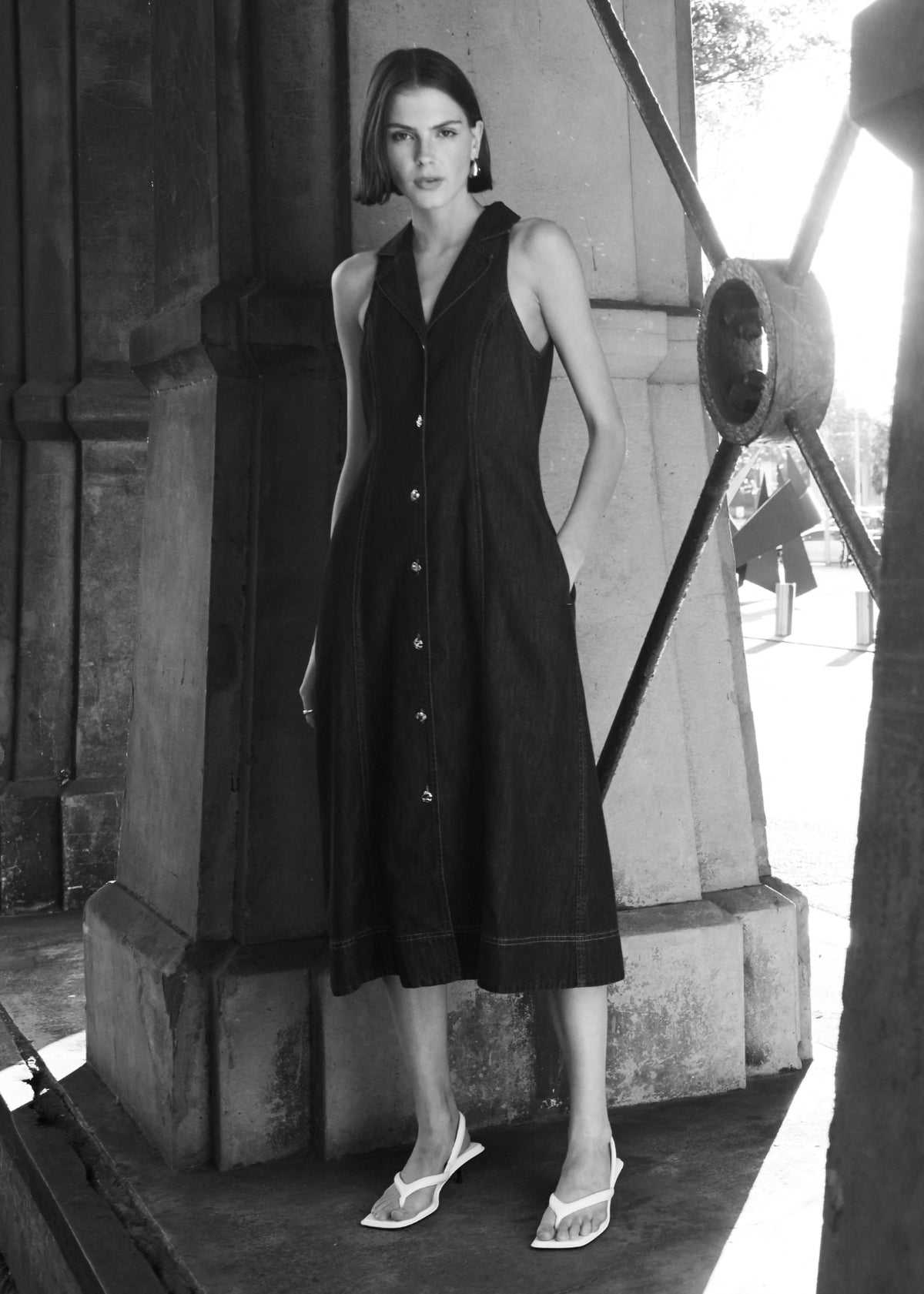 Model wearing Denim Sleeveless Midi Shirt Dress, showing a collared neckline and a button-through front.