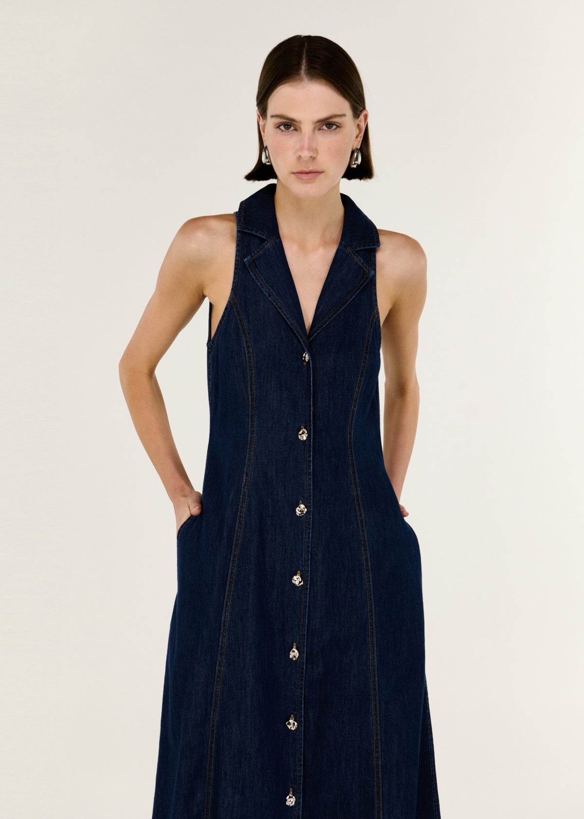 Close-up of the Denim Sleeveless Midi Shirt Dress, showing a sleeveless cut and a collared neckline.