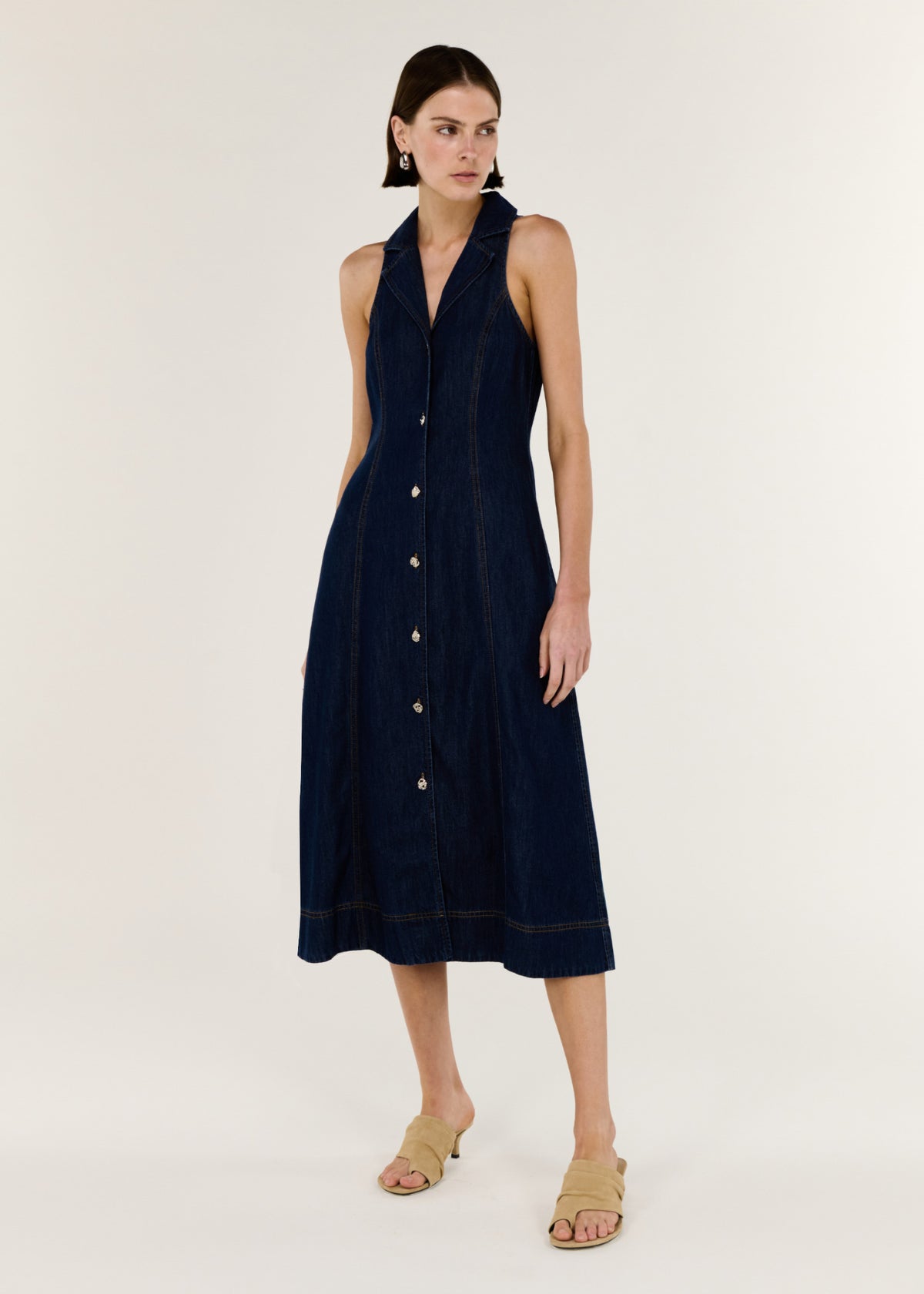 Model wearing Denim Sleeveless Midi Shirt Dress with a sleeveless cut and a collared neckline.