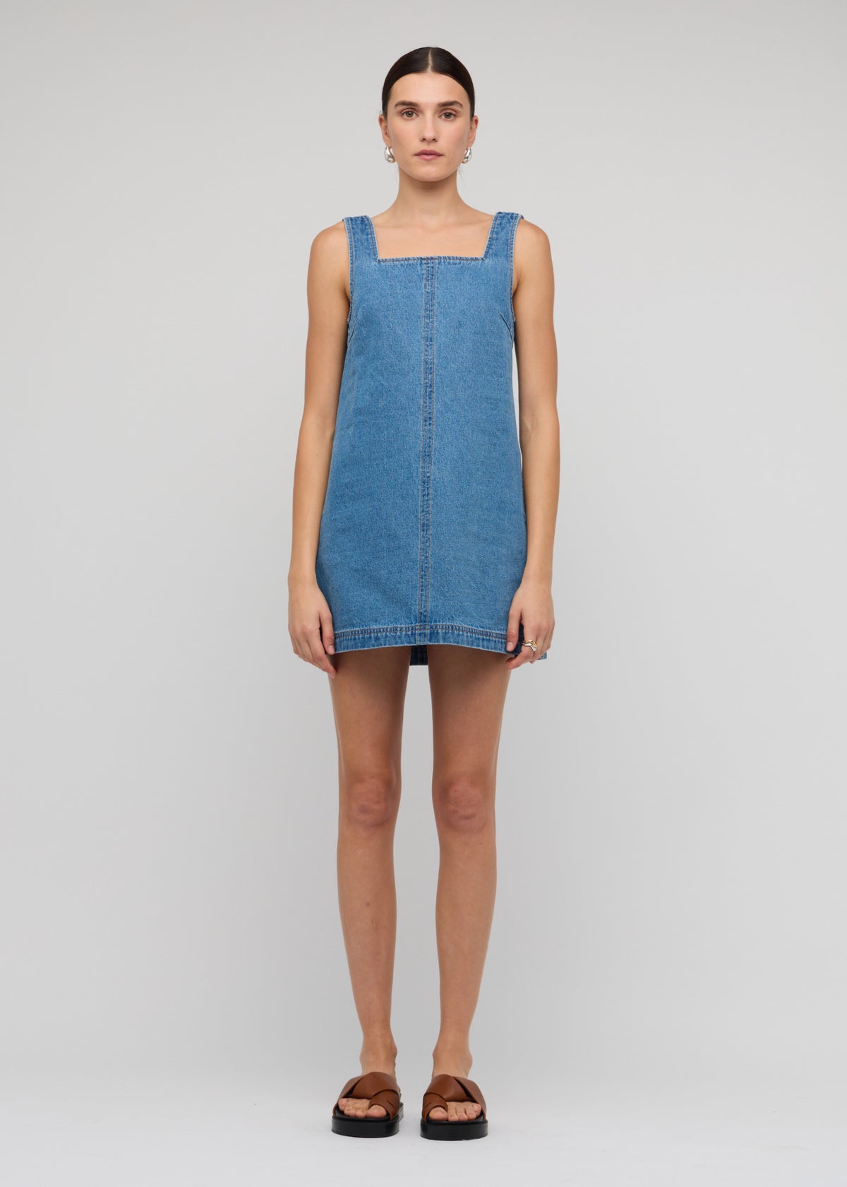 Model wearing Denim Square Neck Mini Dress with a sleeveless cut and a relaxed A-line fit.