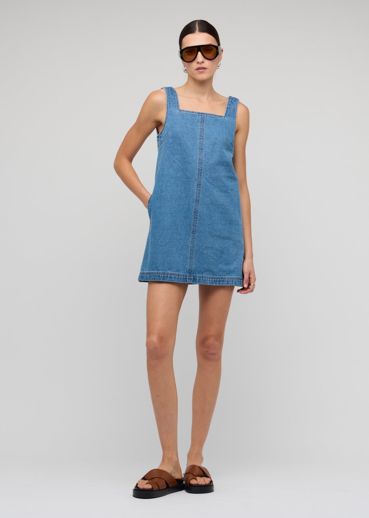 Model wearing Denim Square Neck Mini Dress with a mini length and an easy pull-on style.