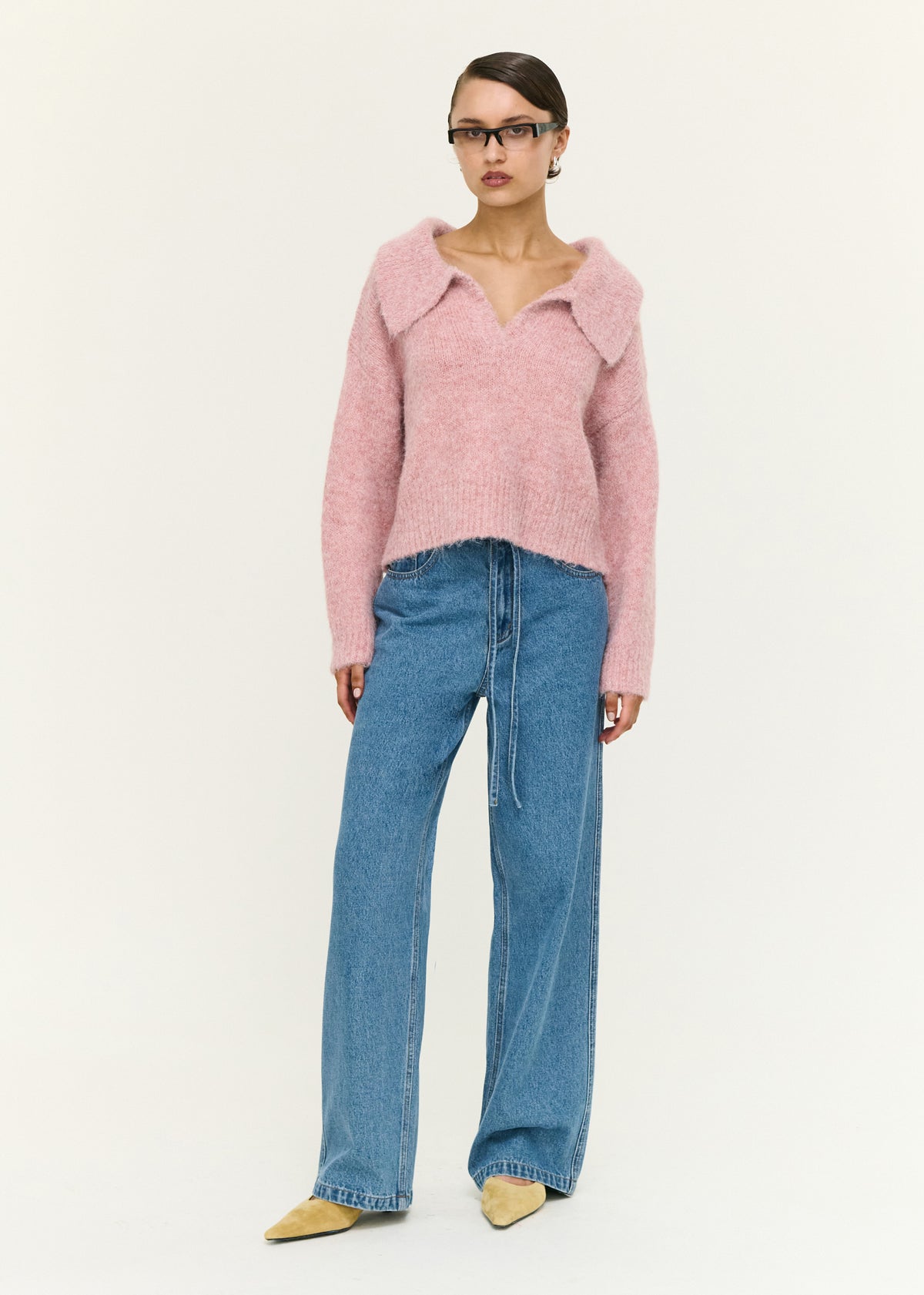 Model wearing Dusky Pink Fluffy Knit Polo Jumper with long sleeves, turned to the side.