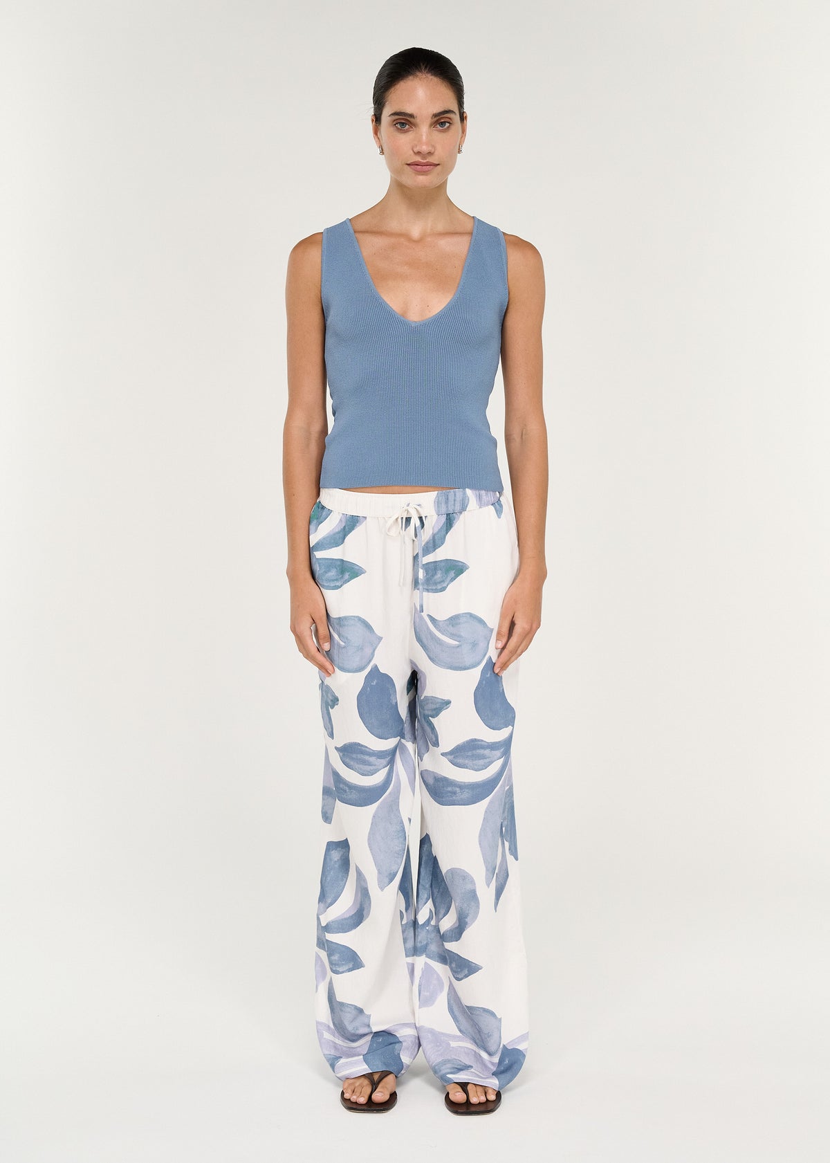 Model wearing Relaxed Drawstring Pant in Blue Floral with a blue top, showcasing wide-leg silhouette and floral print.