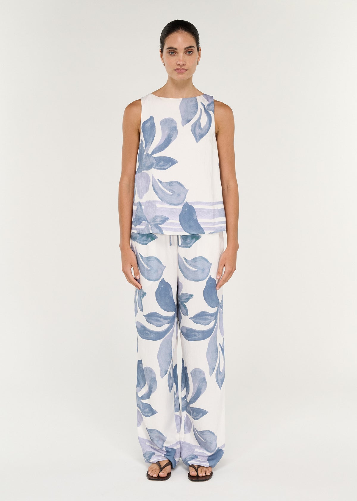 Boatneck Sleeveless Top in Blue Floral worn with matching wide-leg pants, featuring a high round neckline and relaxed fit.