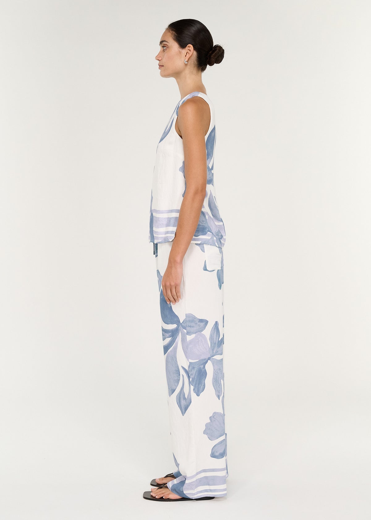 Boatneck Sleeveless Top in Blue Floral worn with matching Elody pant, showcasing a high round neckline and relaxed fit.